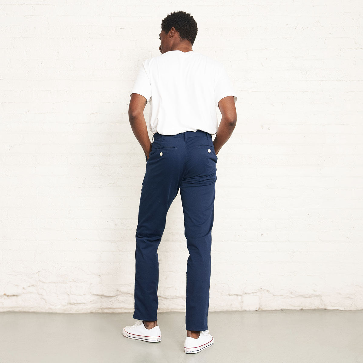 Man wearing the navy stretch chino, back view.