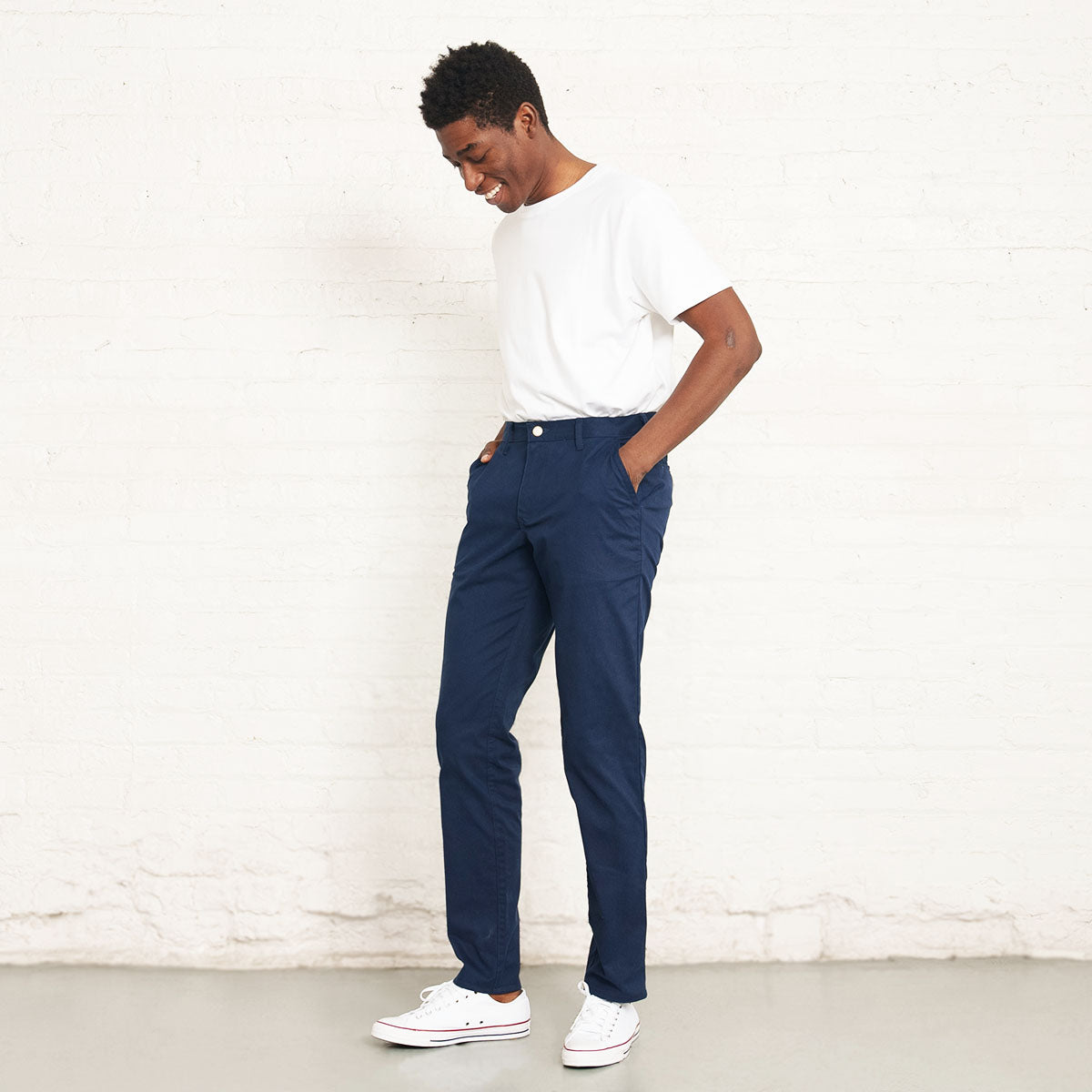 Navy stretch chino styled with a shirt tucked in at the waist.