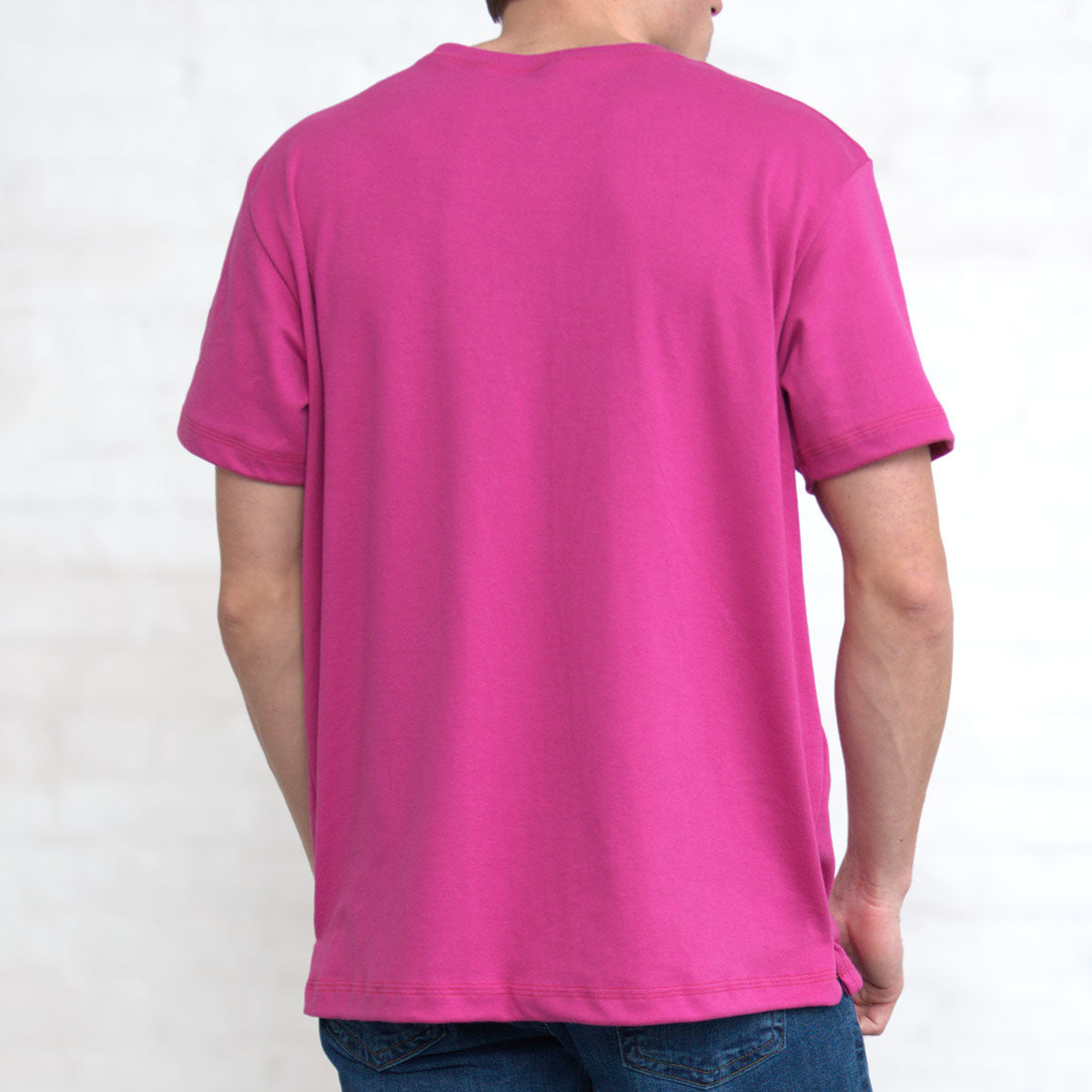 Close-up of the fitted crew neck collar on the magenta t-shirt