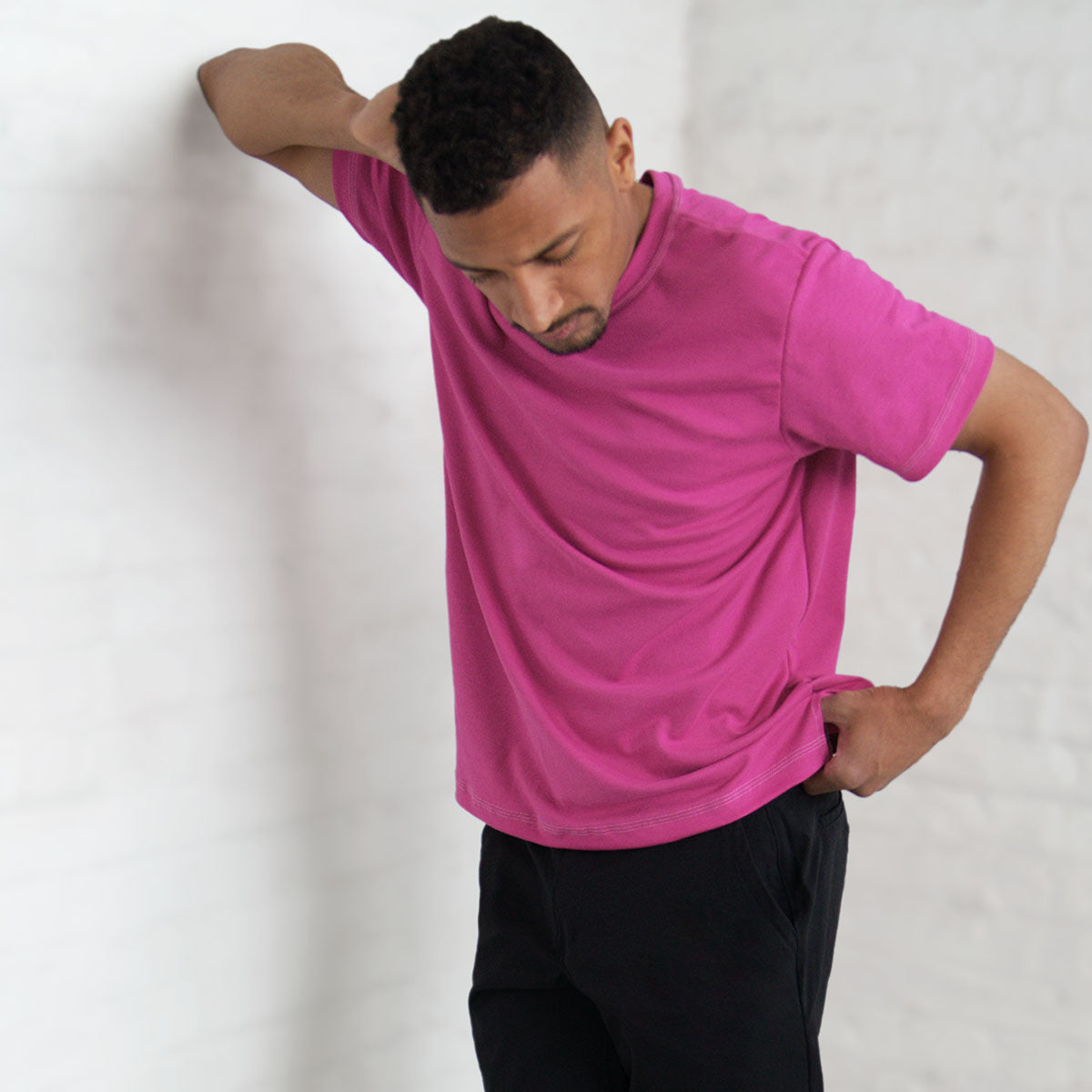 Man wearing the magenta Classic Supima t-shirt