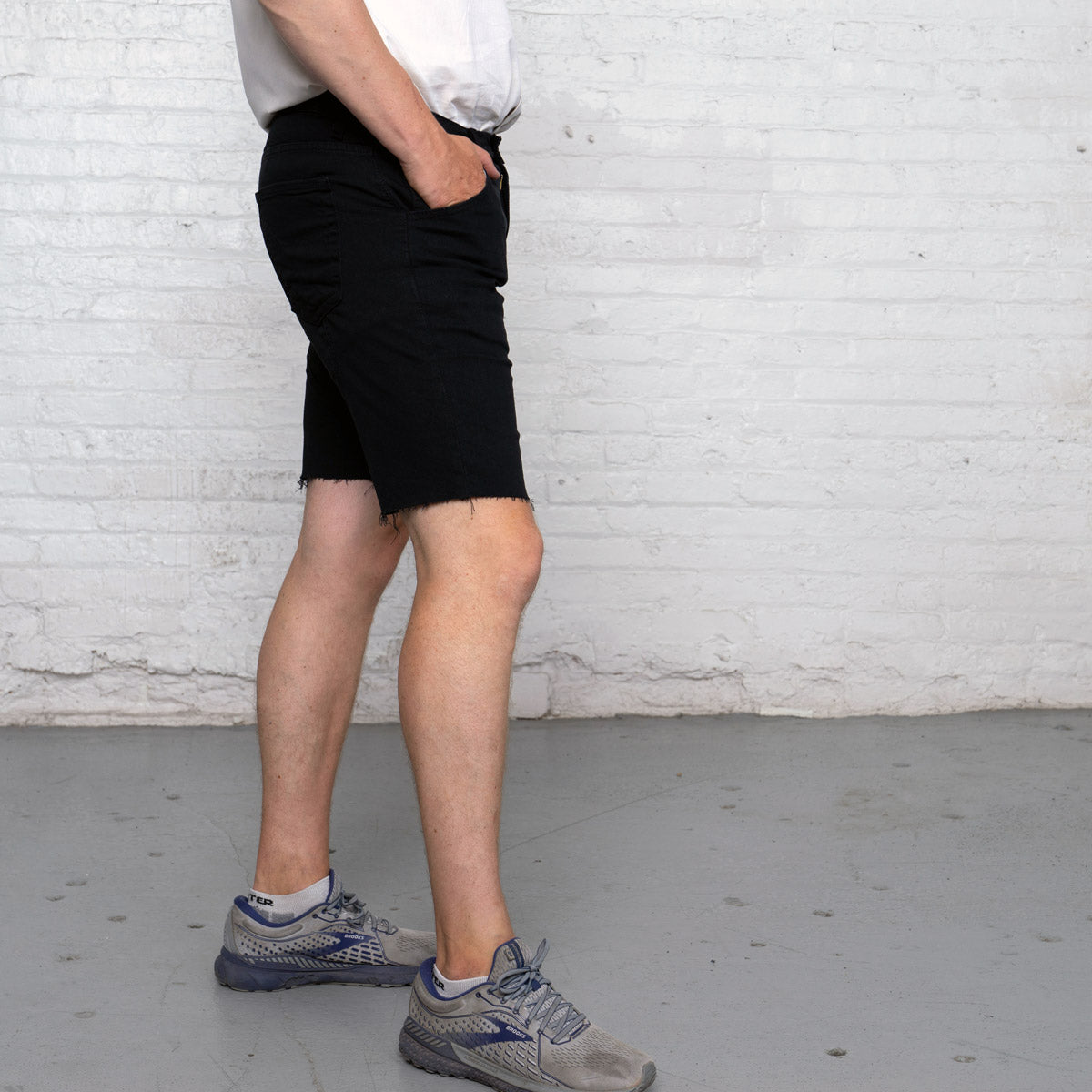Detail of the YKK zipper fly and front pocket on the black commuter shorts.