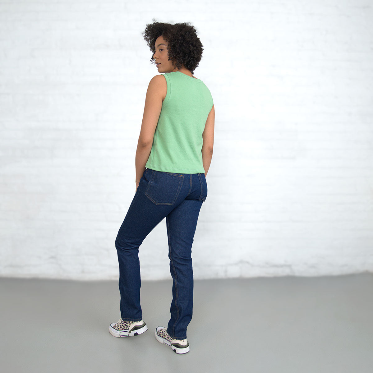 Jade sleeveless crop tank shown full length on a model