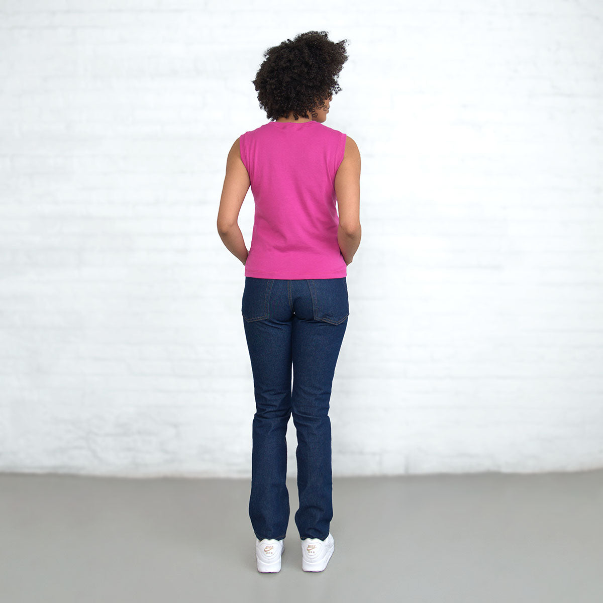 Magenta sleeveless crop top shown on a hanger
