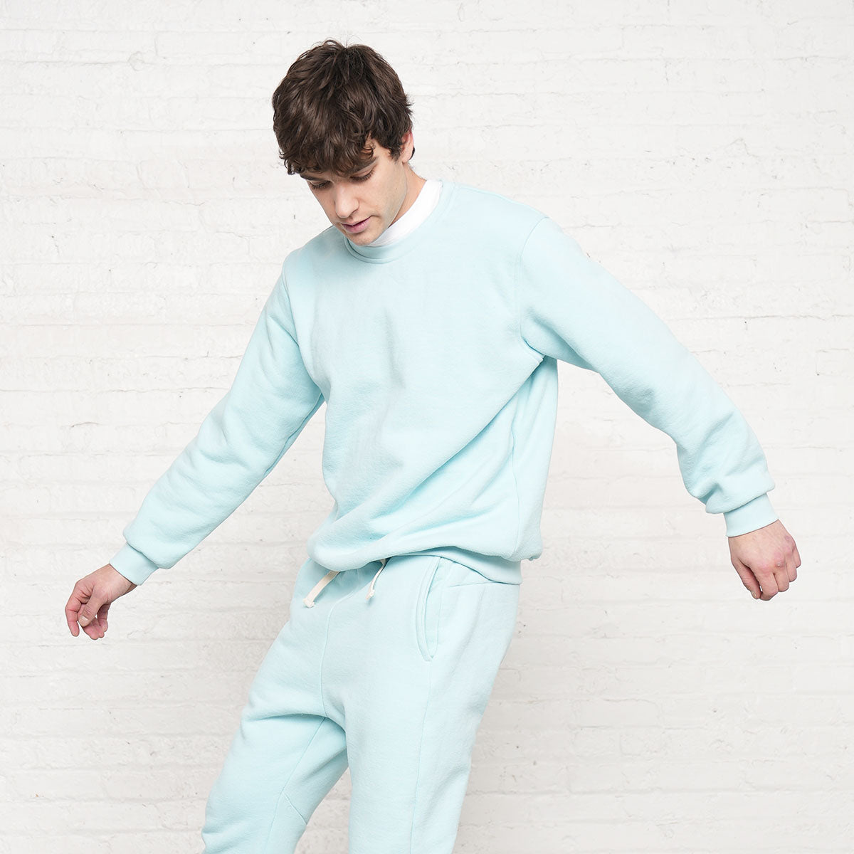 Model wearing the Crystal blue crew neck sweatshirt, front