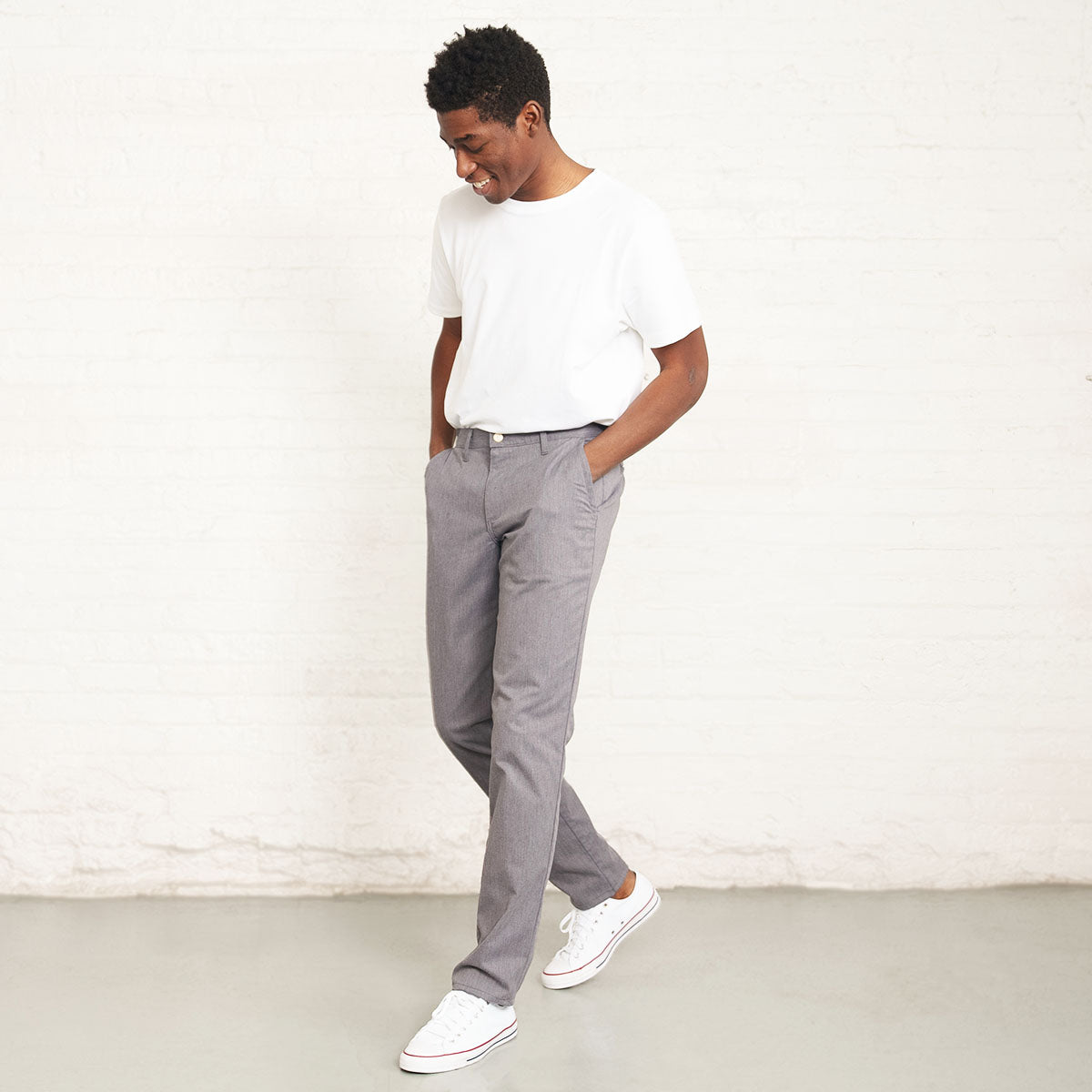 Grey stretch chino worn with a shirt tucked in, waist detail