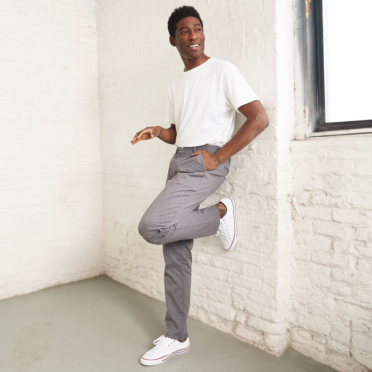 Back view of grey stretch chino pants showing welt pockets