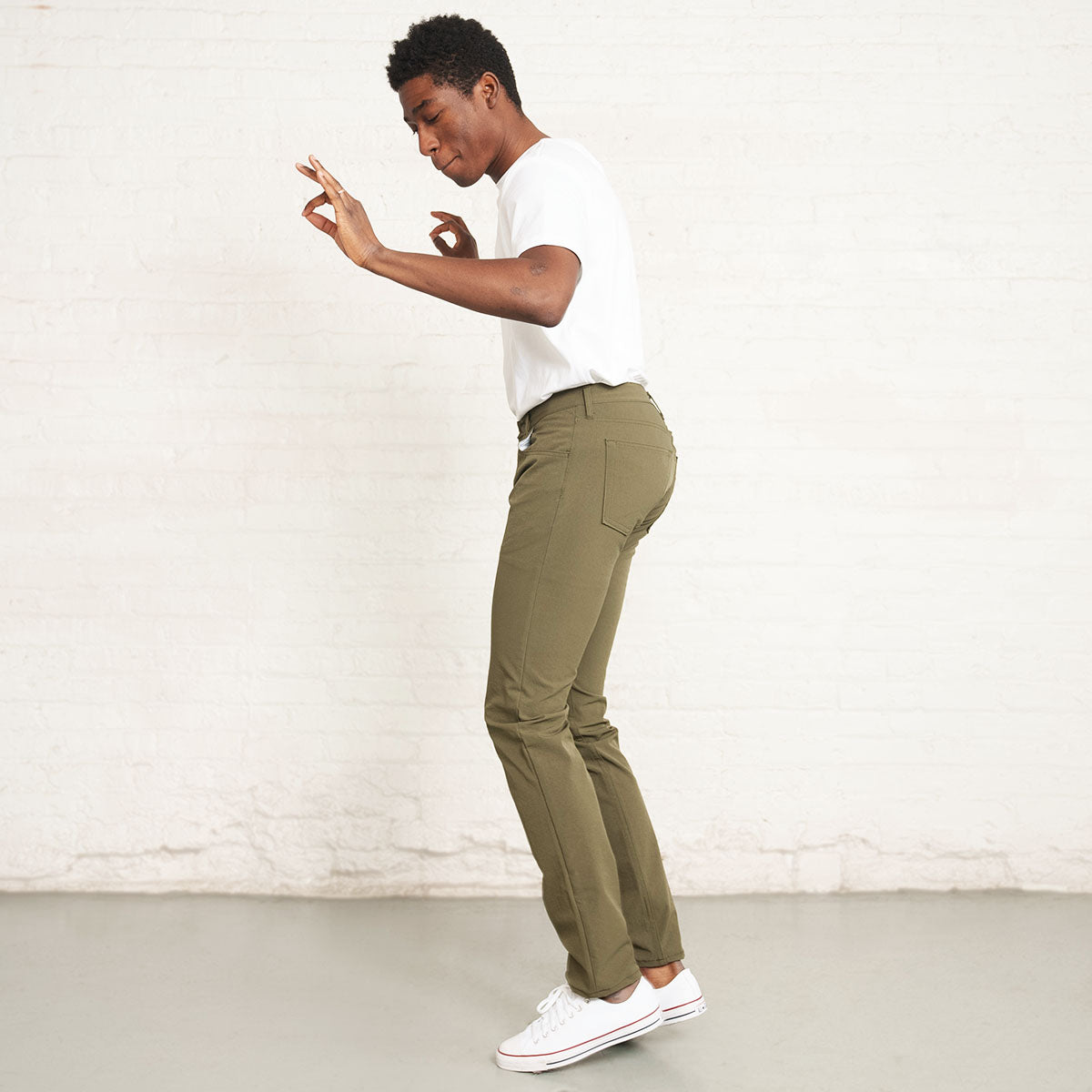 Cuffed hem and leg opening of olive tapered technical jeans