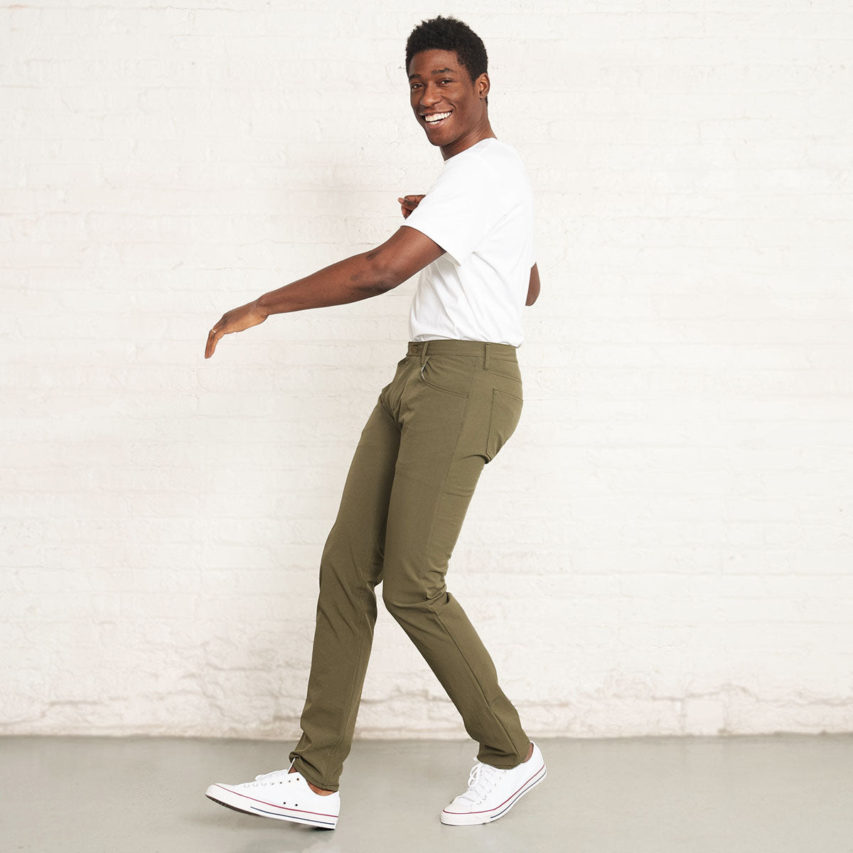 Side view of olive tapered technical jeans on a model