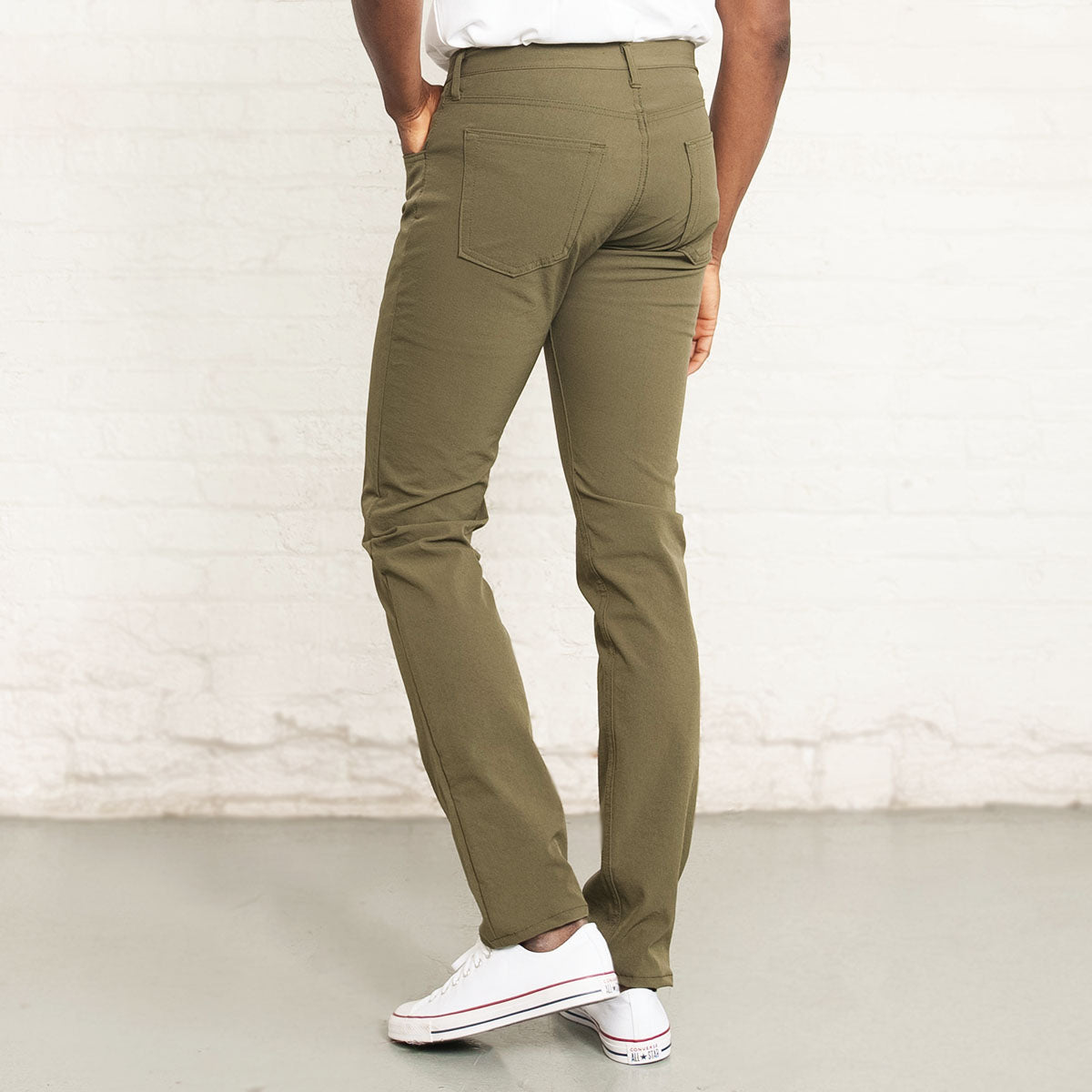 Back view of olive Tailored Technical jeans showing rear pockets