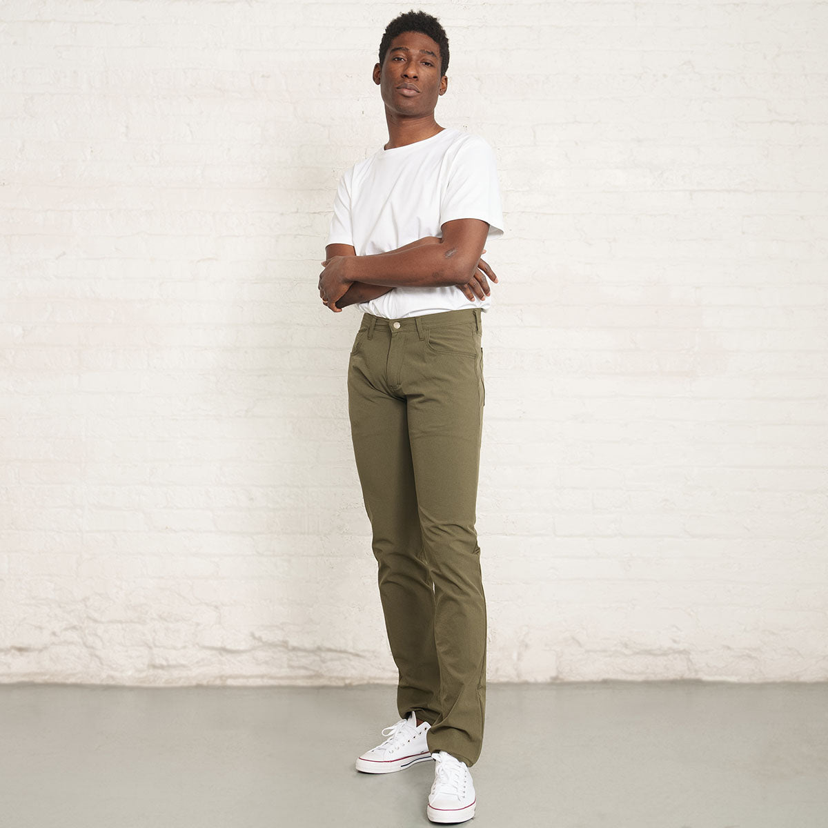 Man wearing olive Tailored Technical jeans, full length front view