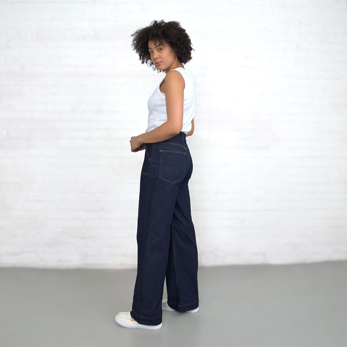 Three-quarter view of a model wearing dark wash wide-leg jeans