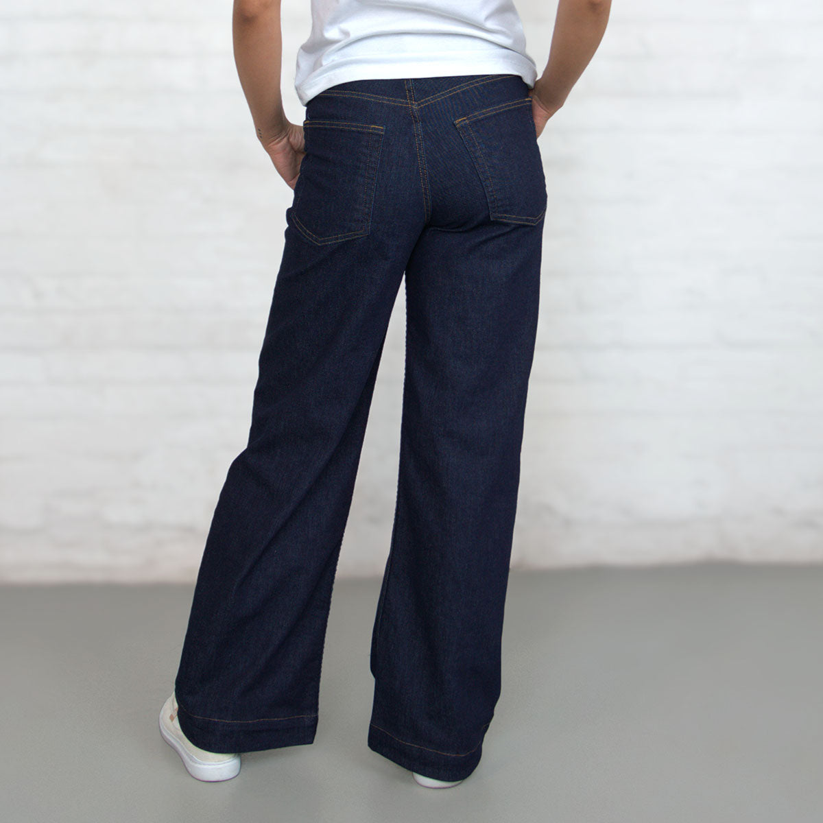 Back view of dark wash wide-leg jeans showing oversize back pockets