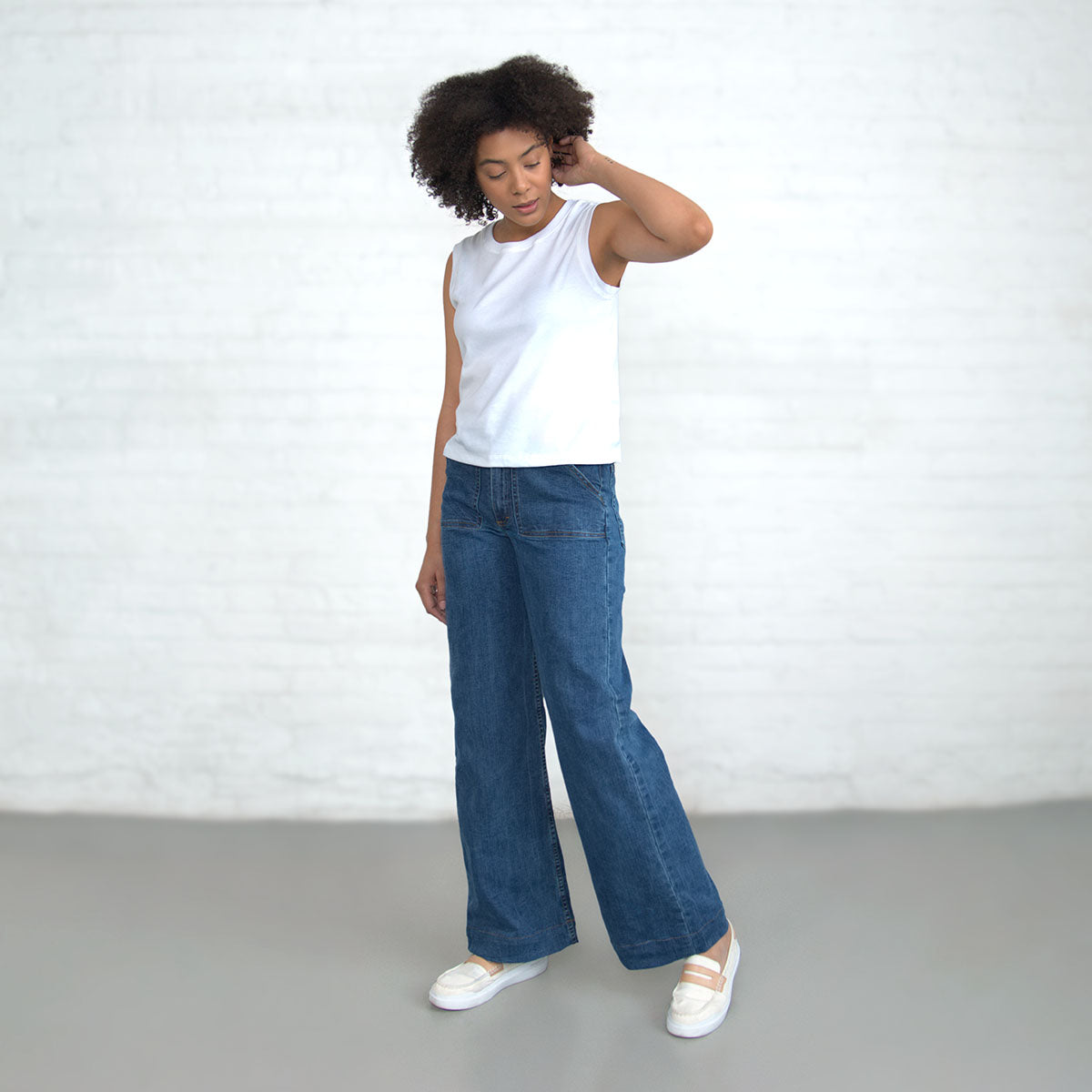 Close-up of the high-rise waistband with gold leaf button and belt loops