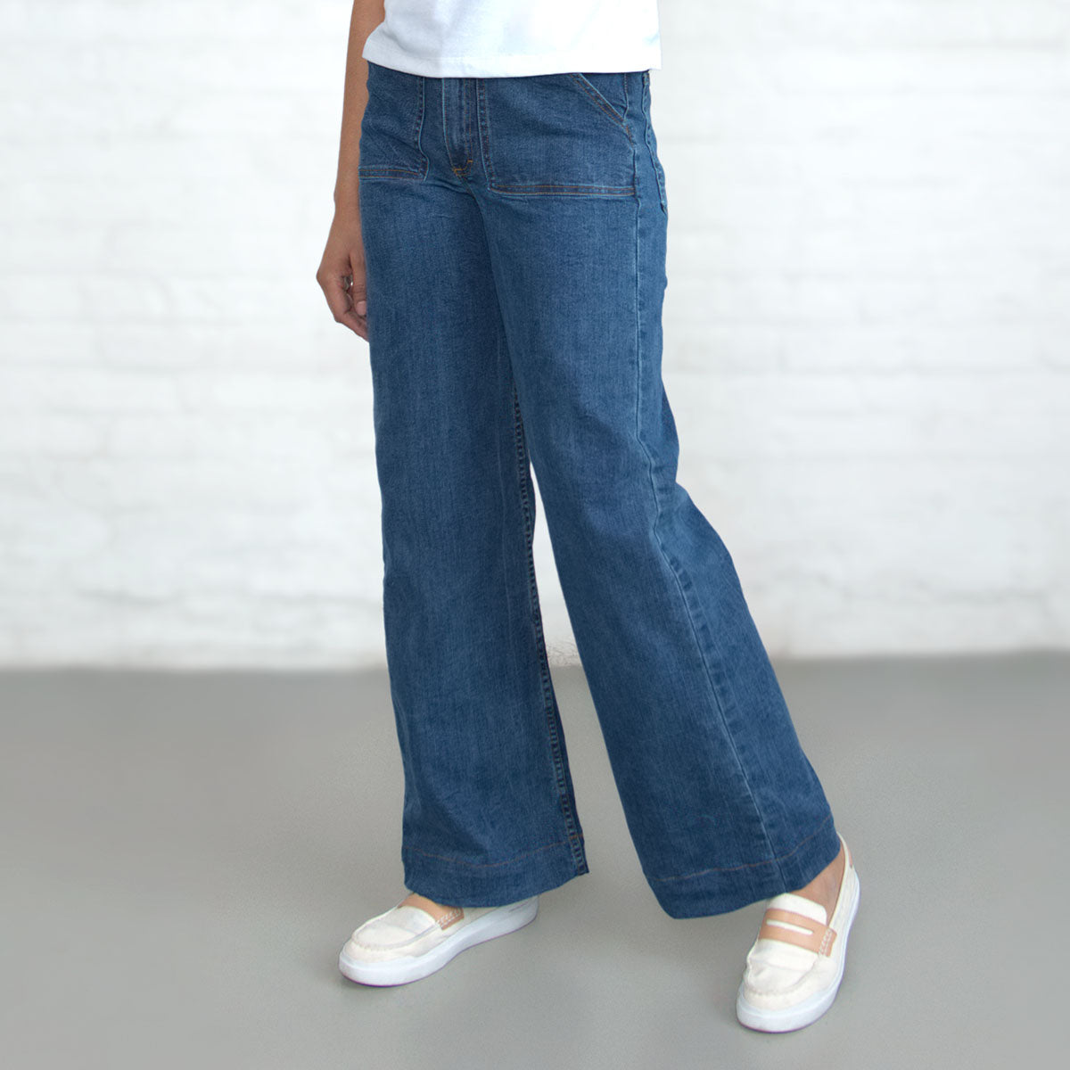 Back view of light wash wide-leg jeans showing oversize back pockets