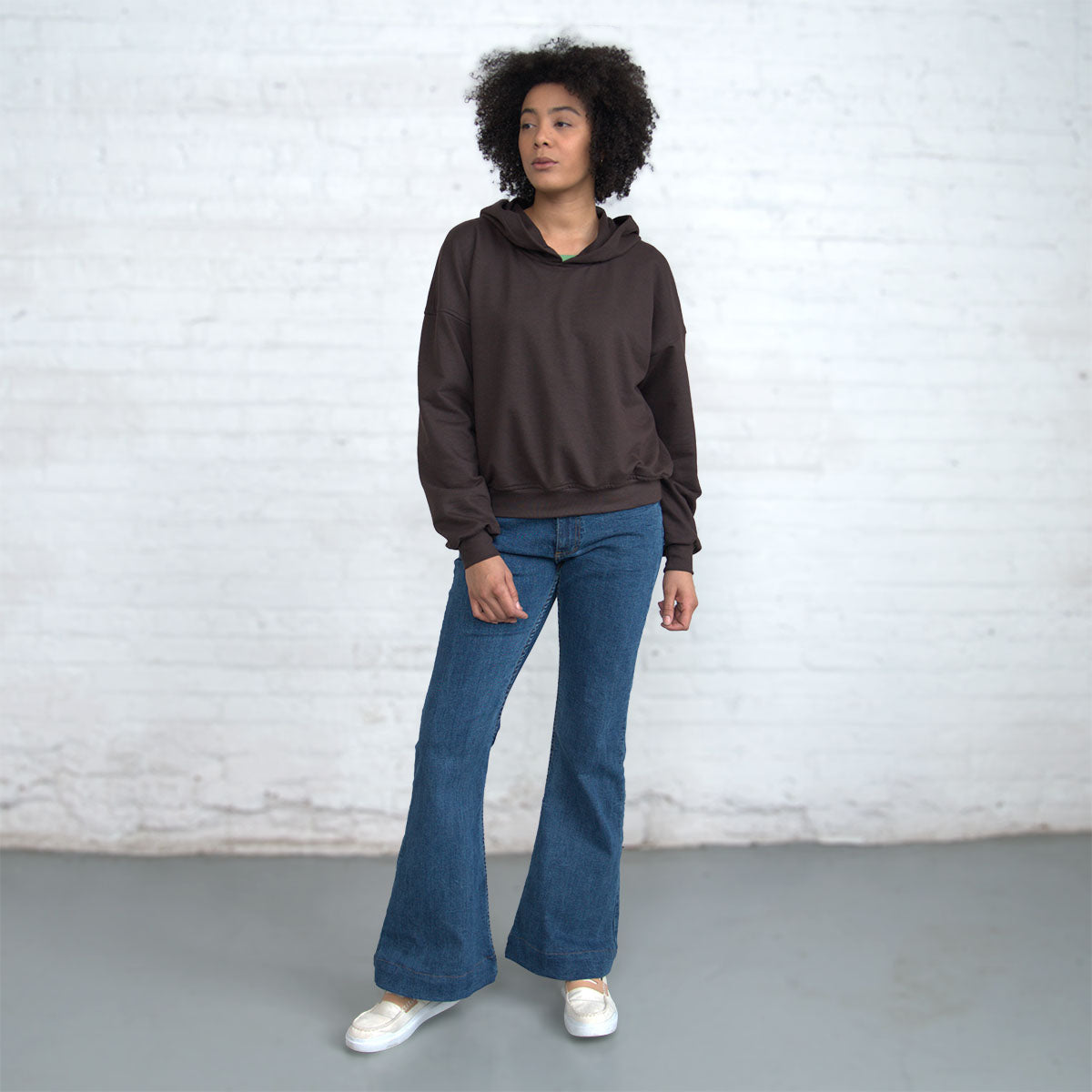 Side view showing the drop shoulder seam and loose sleeve.