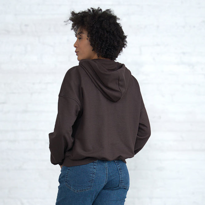 Back view of the cropped hooded sweatshirt showing the enlarged hood.