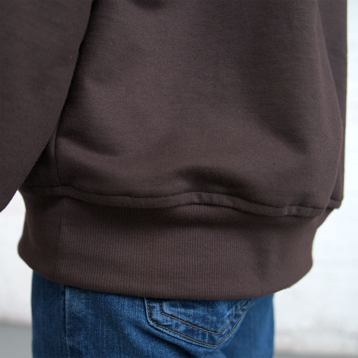 Side view of the Spring Hoodie worn with jeans