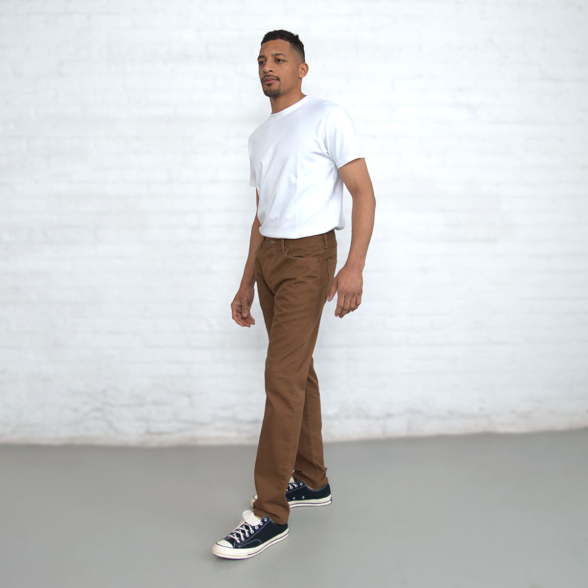 Tapered leg and hem of the brown jeans