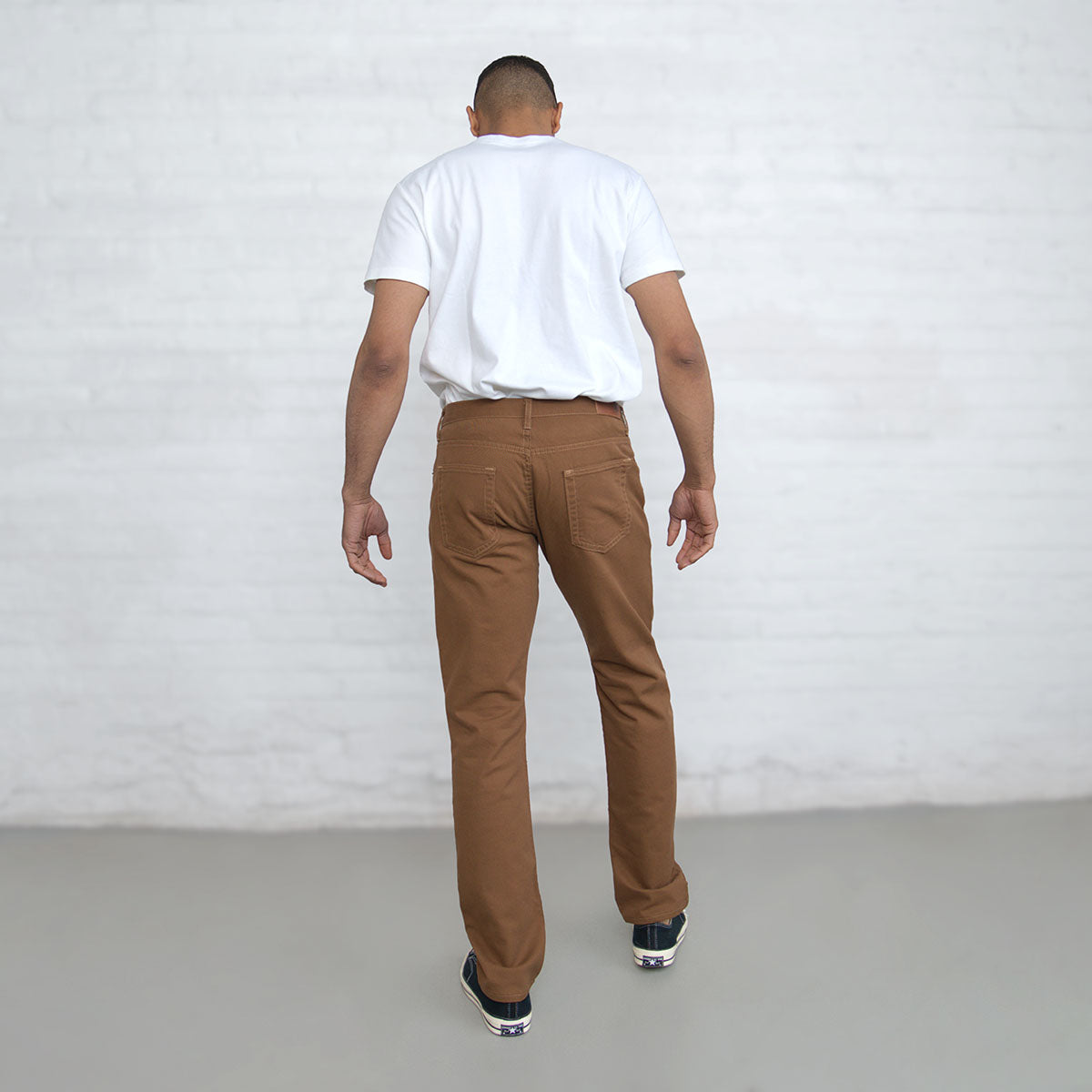 Man wearing brown Tailored Fit jeans, full front view