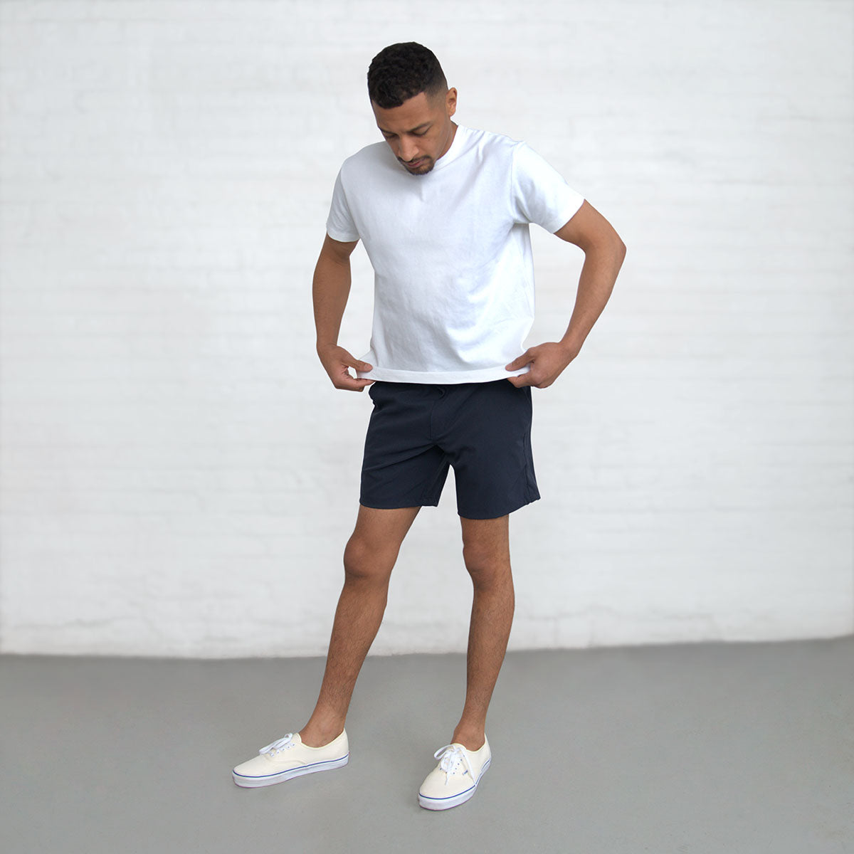 Waistband and belt loop detail on the navy technical shorts.