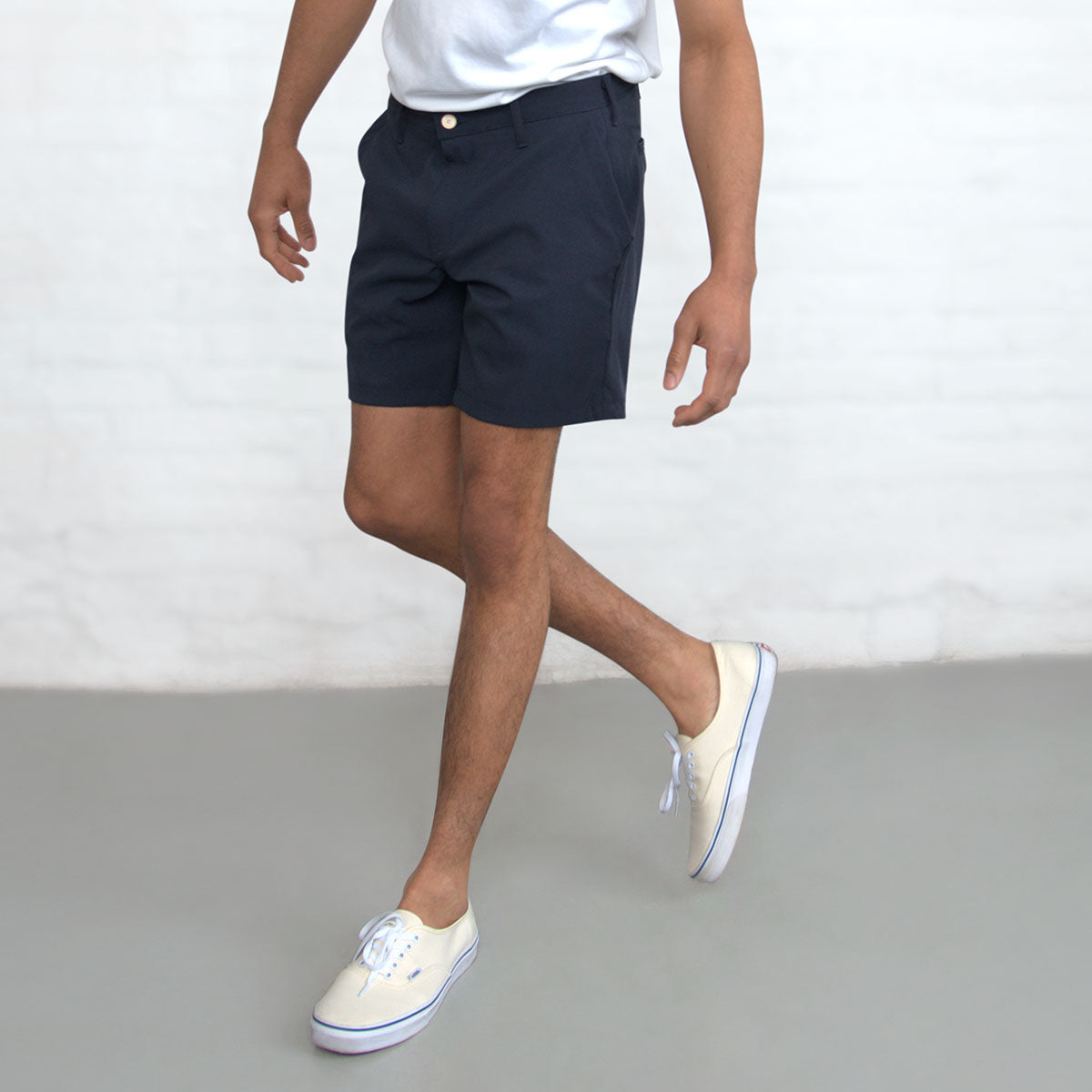 Back view of the navy technical shorts showing the back pockets and waistband.