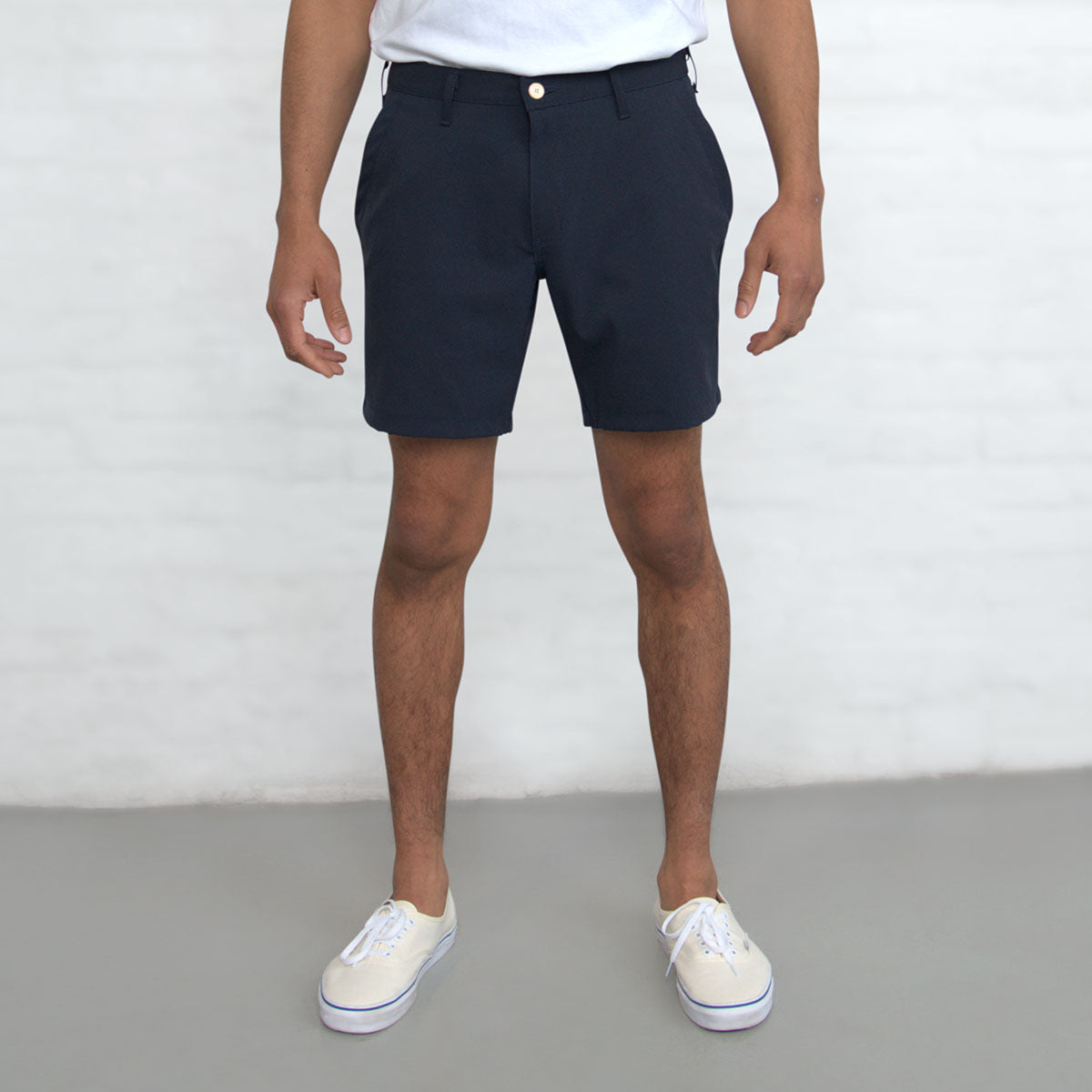 Navy technical shorts shown flat from the front with belt loops and front pockets visible.