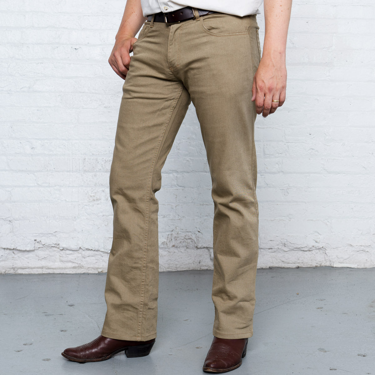 Detail of the Horween leather patch on the back waistband of the khaki boot cut jeans.