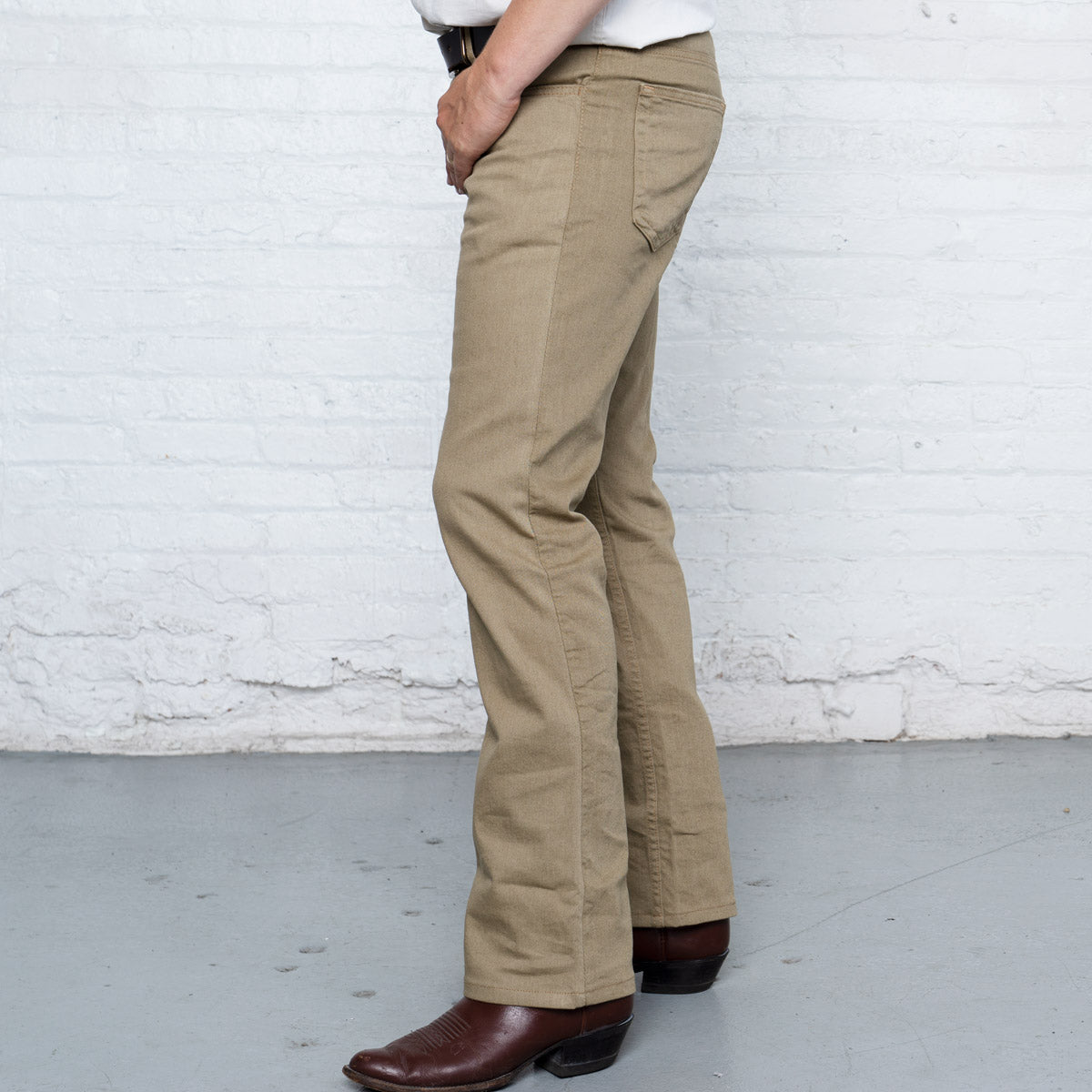 Close-up of the khaki denim fabric, stitching and YKK zipper fly.