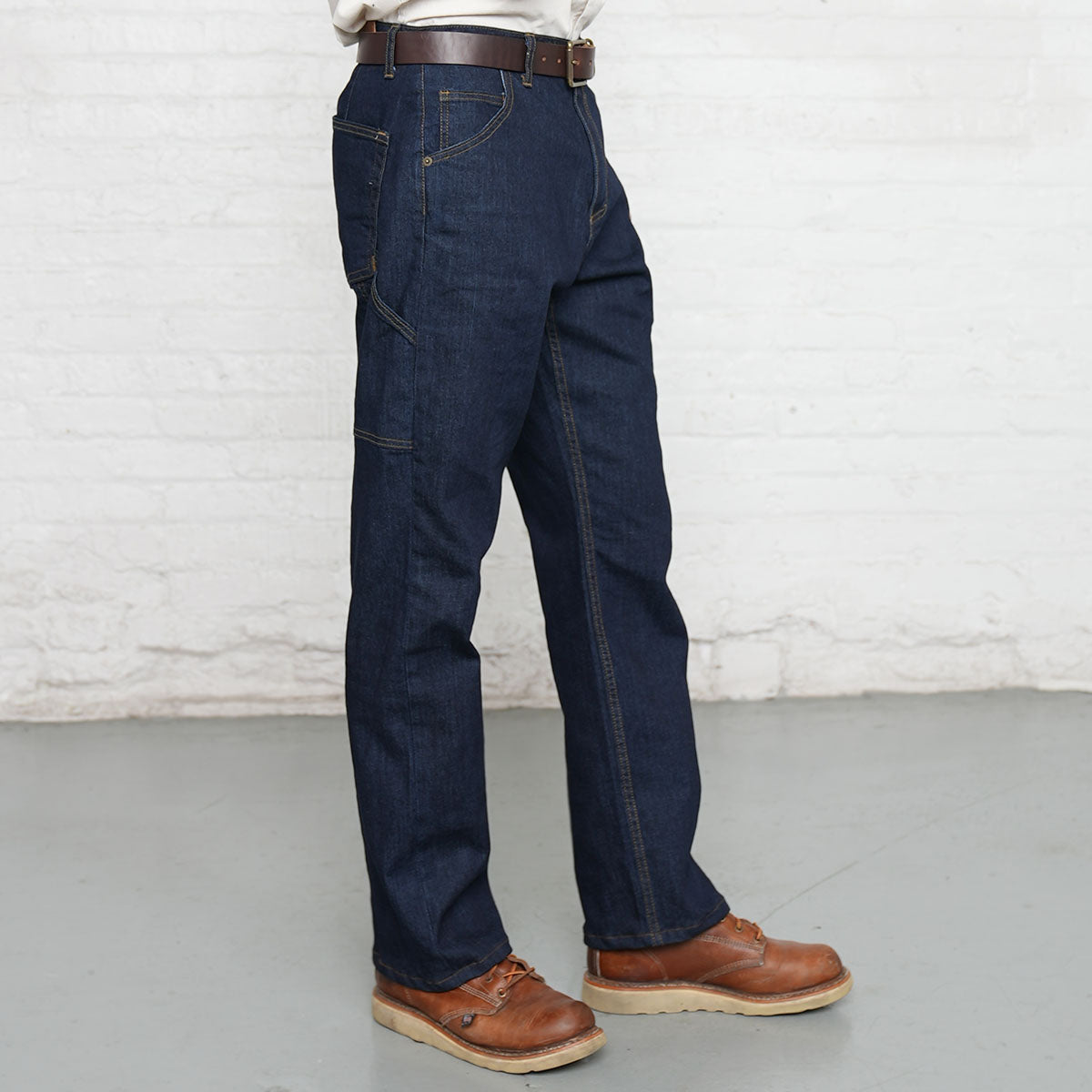Detail of YKK zipper fly and belt loops on dark wash carpenter jeans
