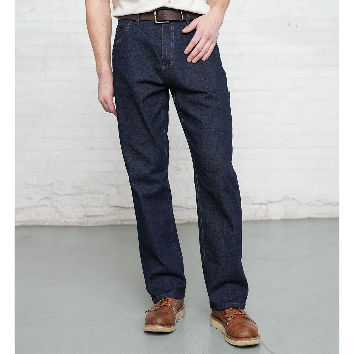 Back view of dark wash carpenter jeans showing large back pockets and darts