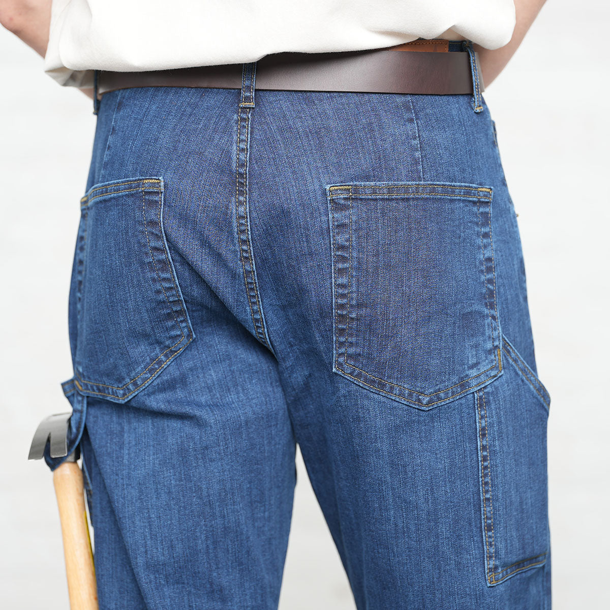 Close-up of the hammer loop and pencil pocket on medium wash carpenter jeans