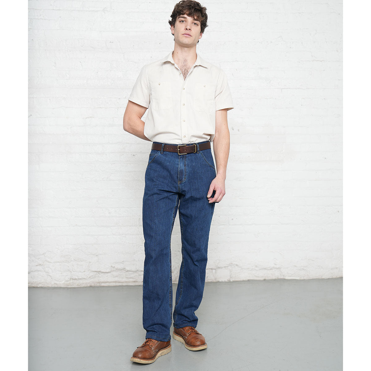 Close-up of the front pocket and belt loops on medium wash stretch denim jeans