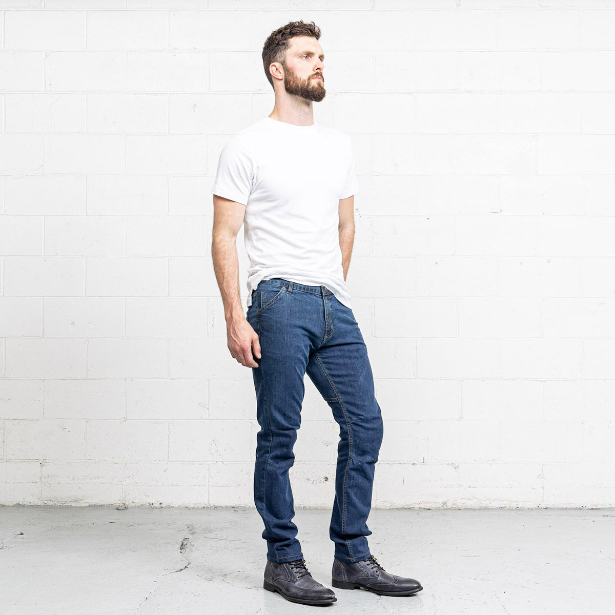 Back view of Commuter medium wash jeans showing back pockets and Horween leather patch.
