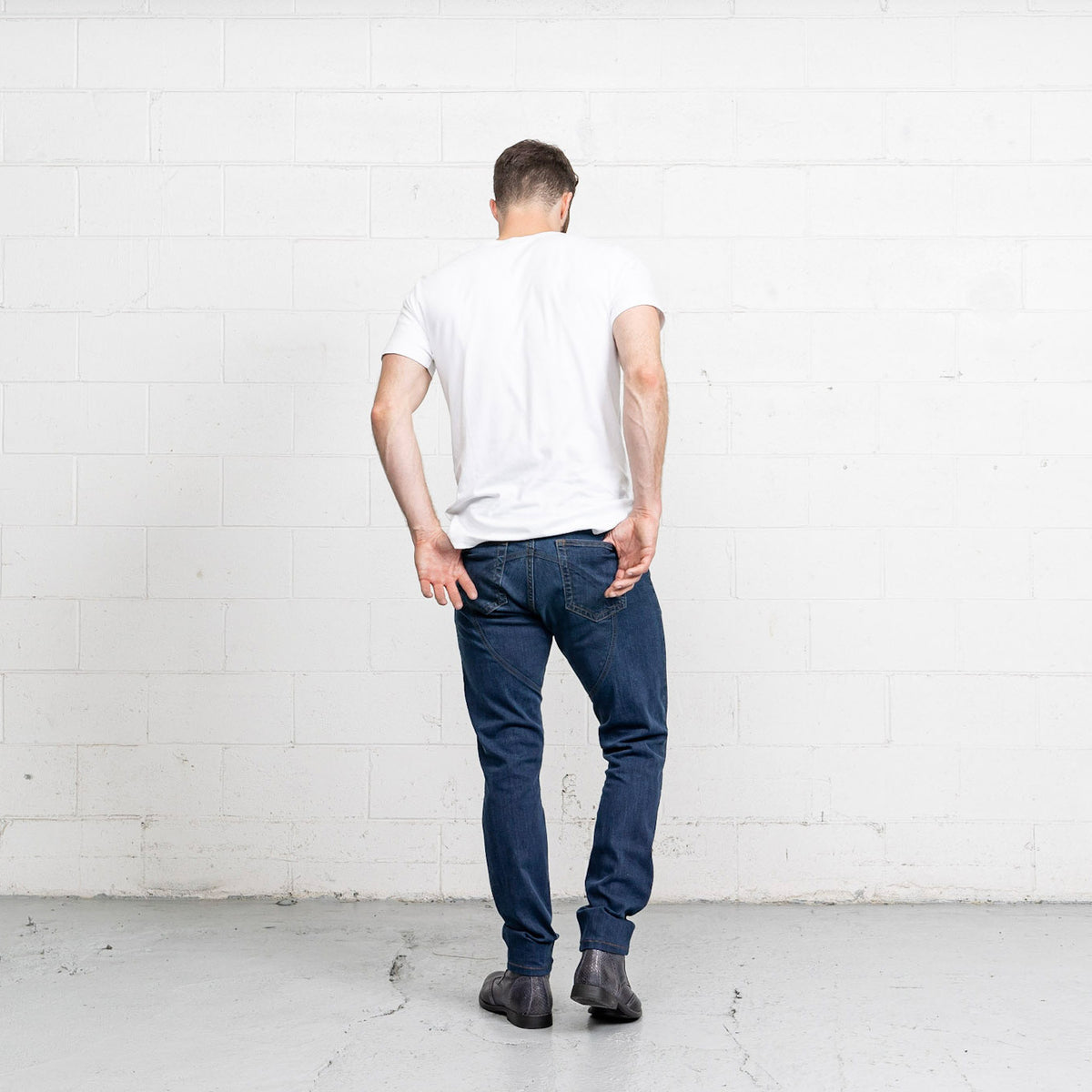 Close-up of the stone washed medium wash tri-blend stretch denim fabric.