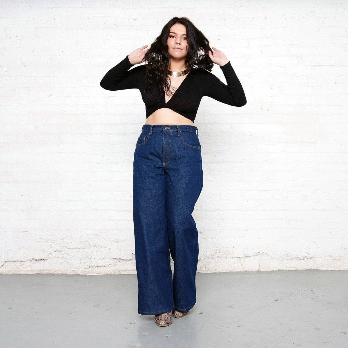 Side view of the wide leg jeans showing the high rise and full leg.