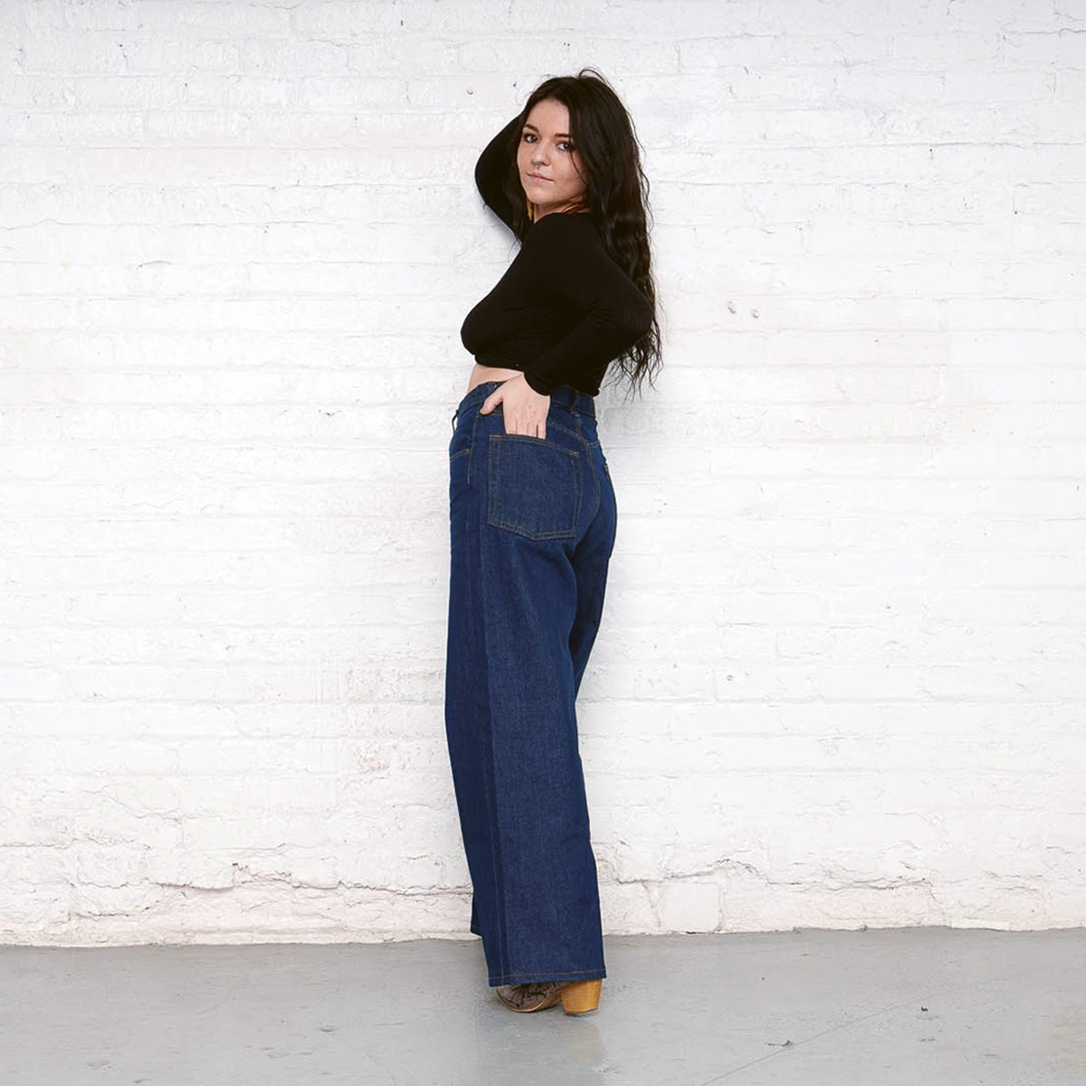 Back view of the dark wash Palazzo jeans showing oversize back pockets and leather patch.