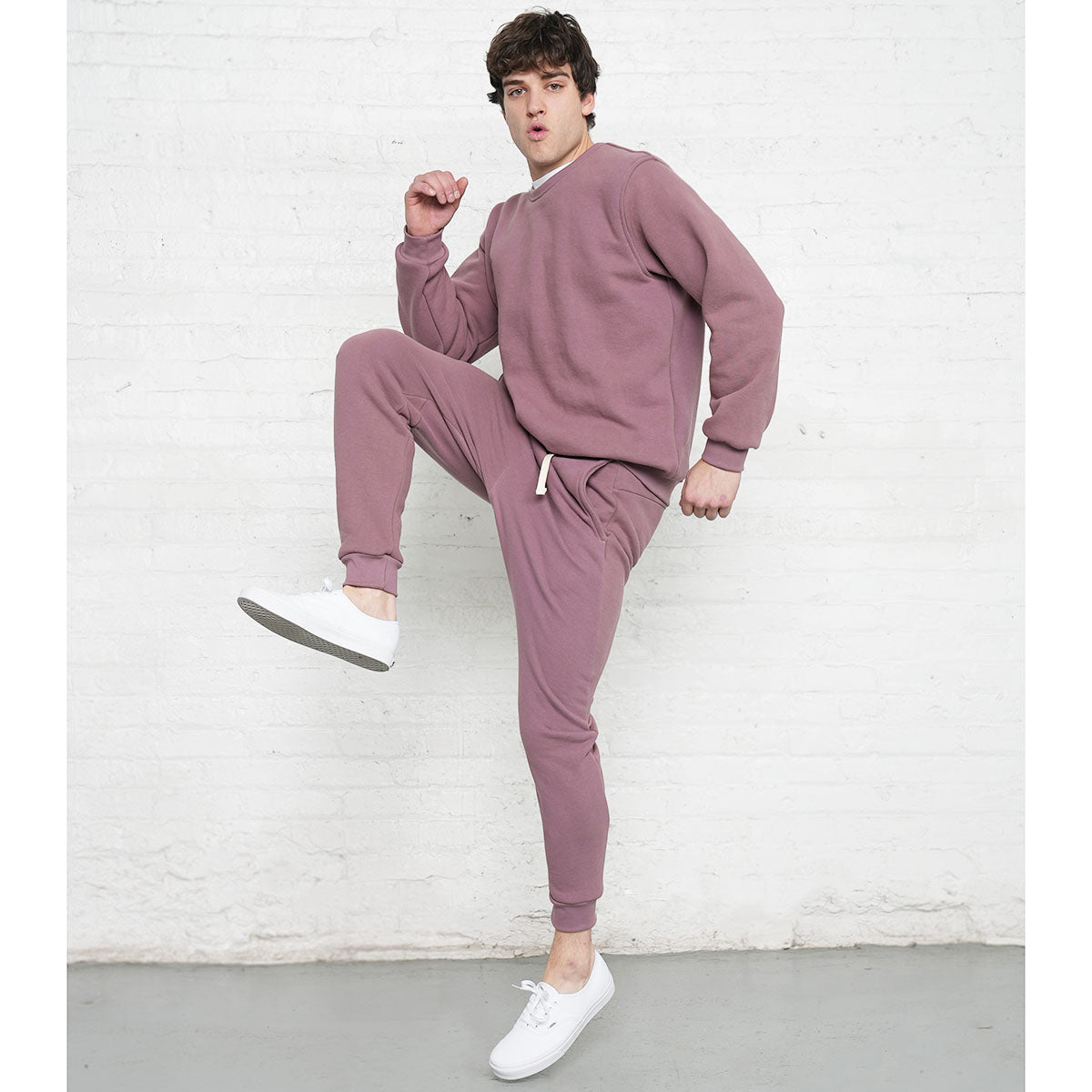 Back view of rose taupe sweatpants showing seat, back pocket and tapered leg.