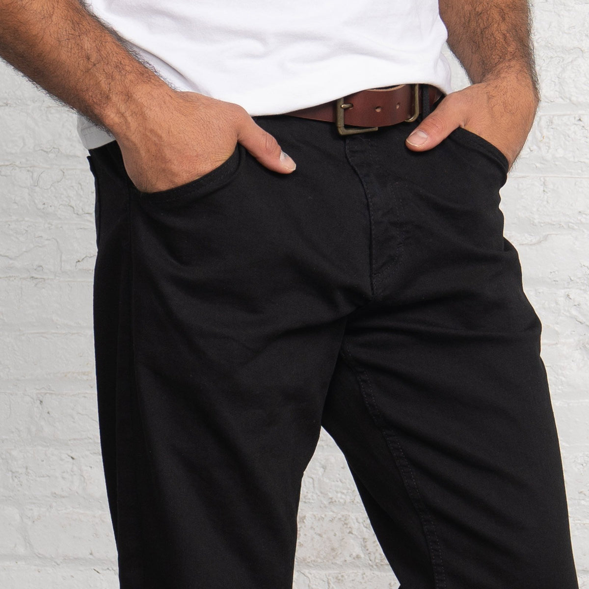Close-up of the black triblend stretch denim fabric and stitching.