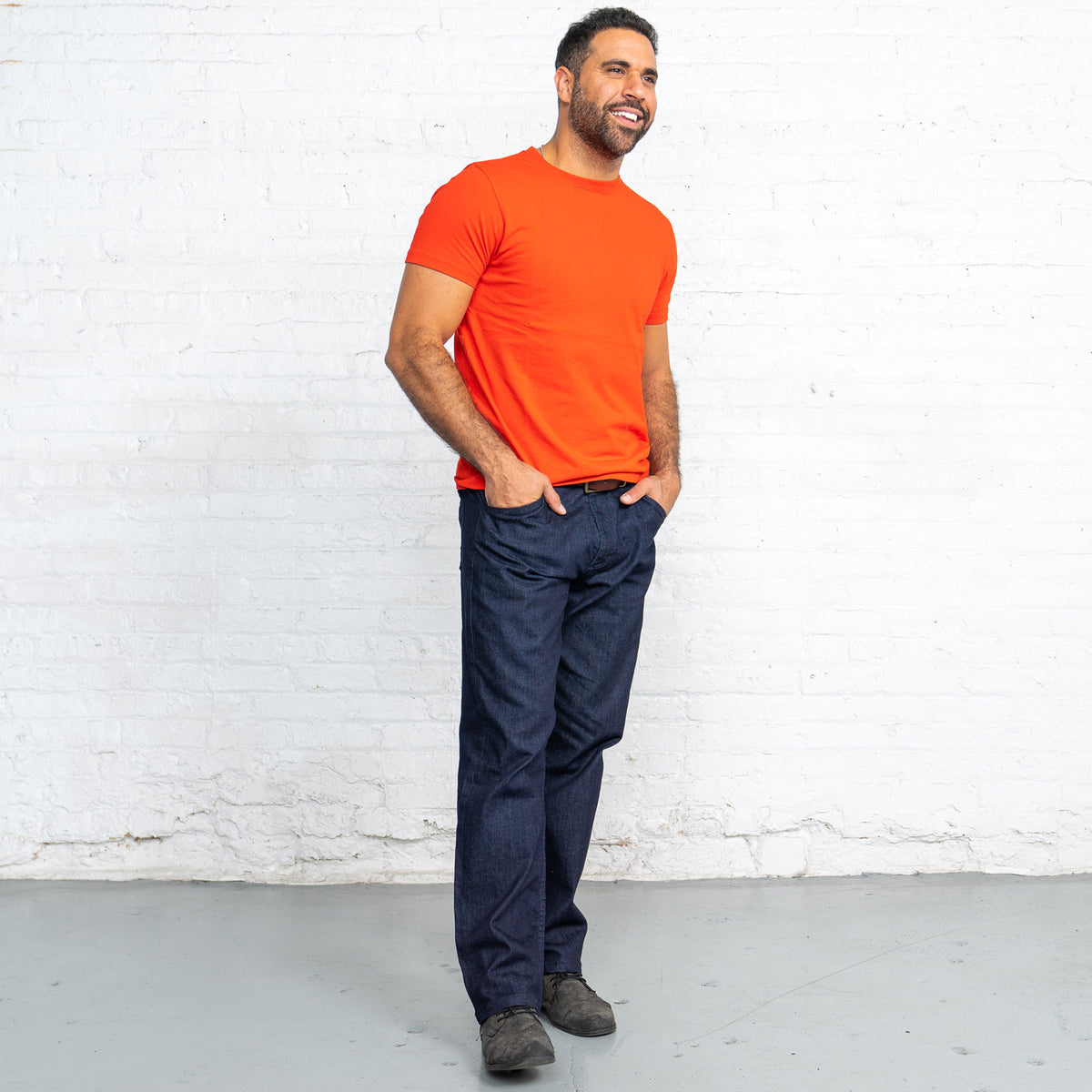 Back view of the dark wash relaxed fit jeans showing back pockets and Horween leather patch.