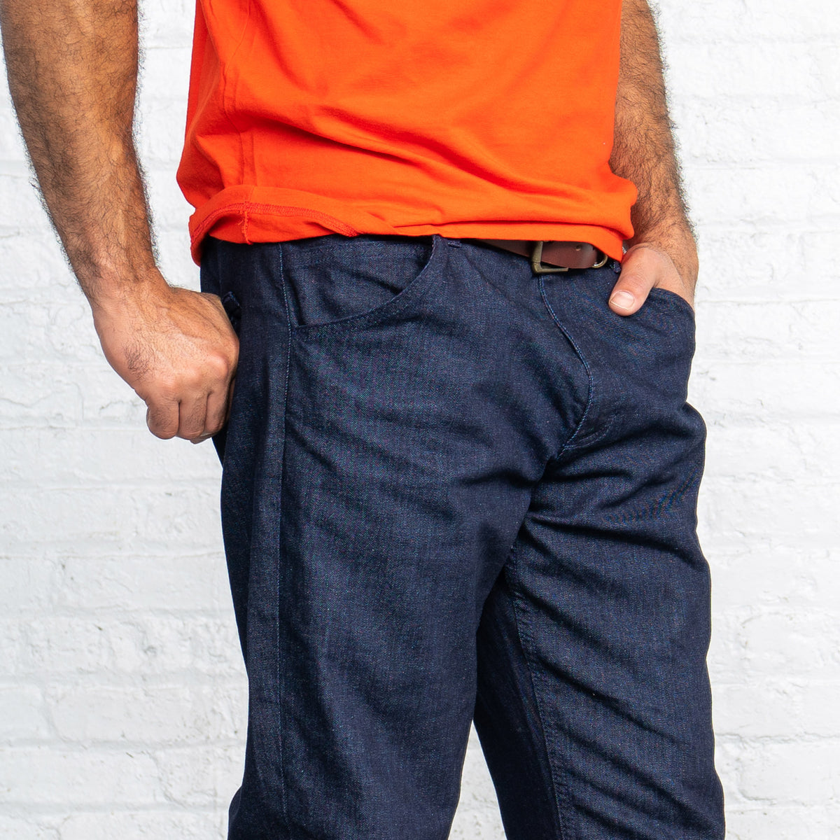 Man wearing the relaxed fit dark wash jeans, showing the medium rise and relaxed leg.