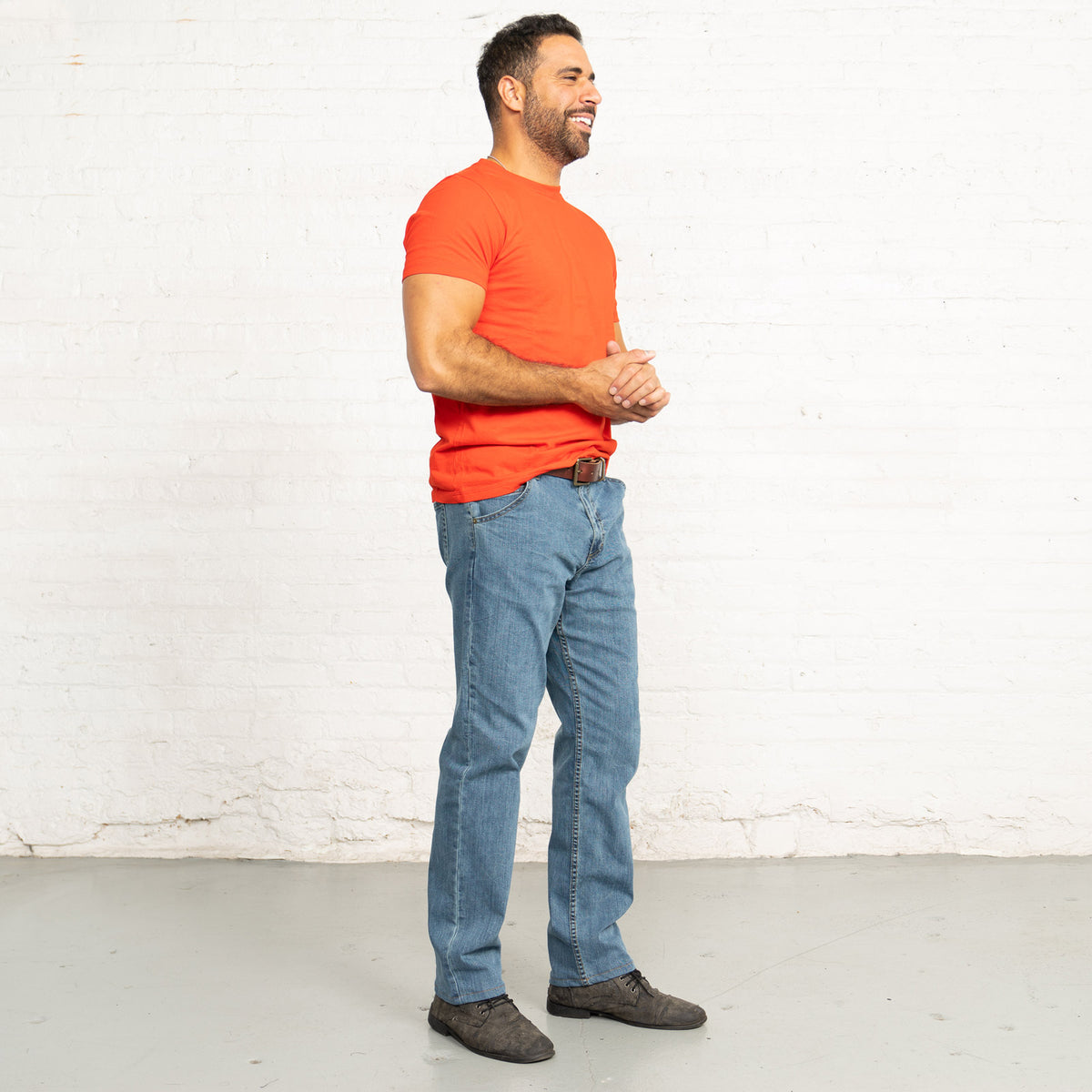 Side view of relaxed fit light wash stretch jeans showing straight leg.