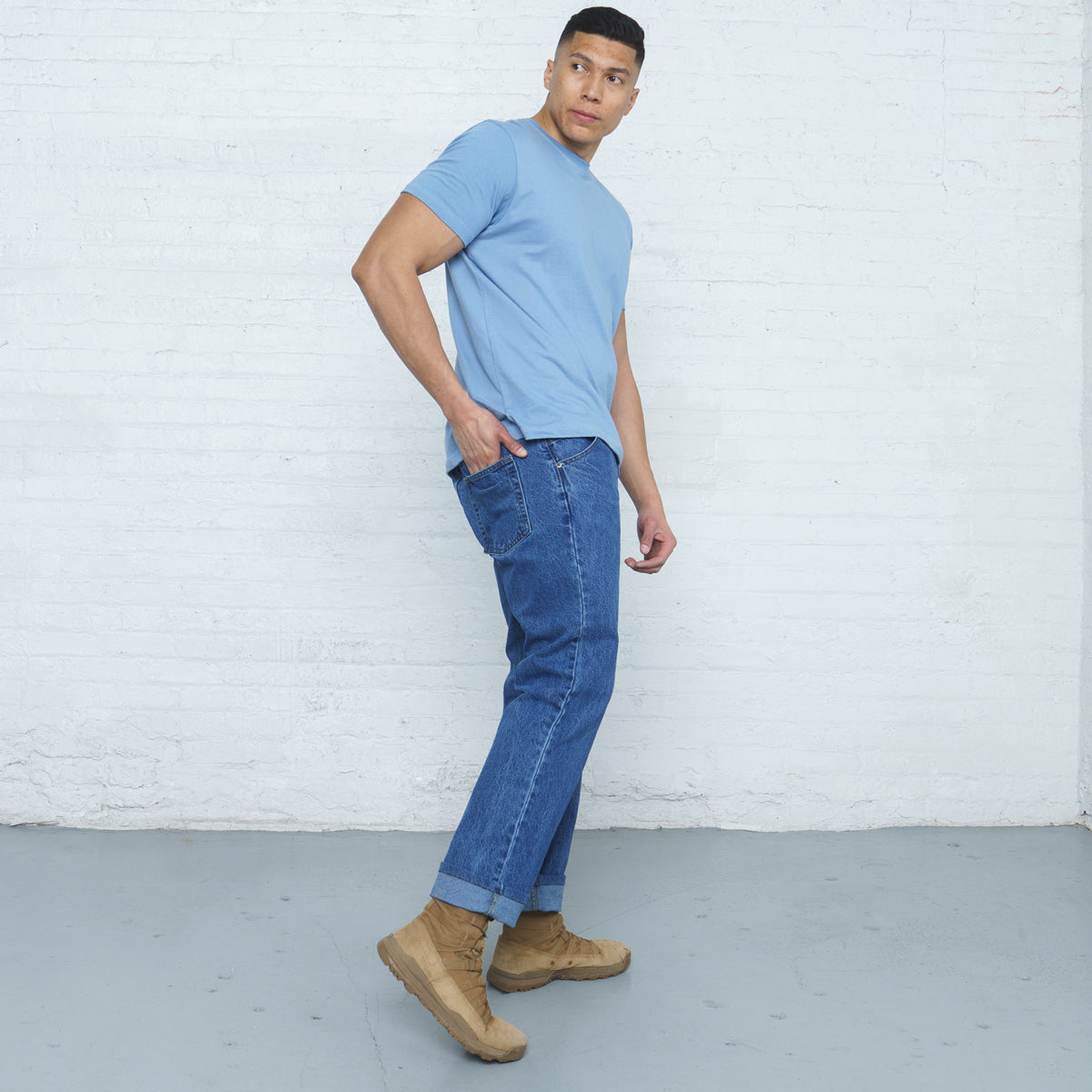 Close-up of the waistband, button and belt loops on stone wash cotton denim jeans