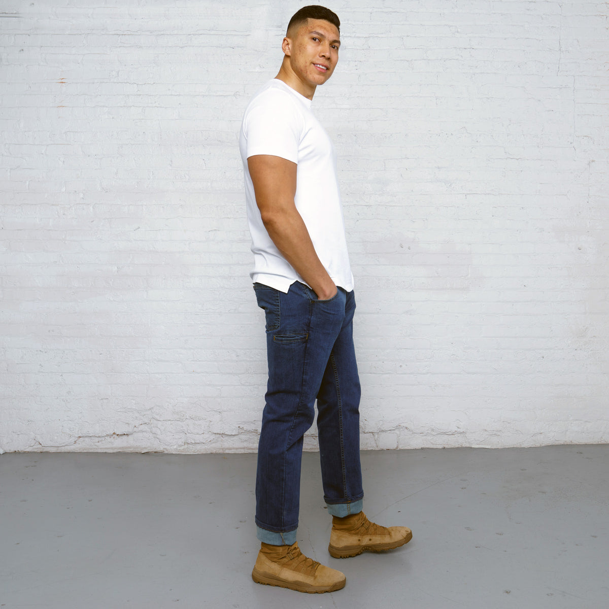 Back view of medium wash relaxed fit jeans showing back pockets and Horween leather patch