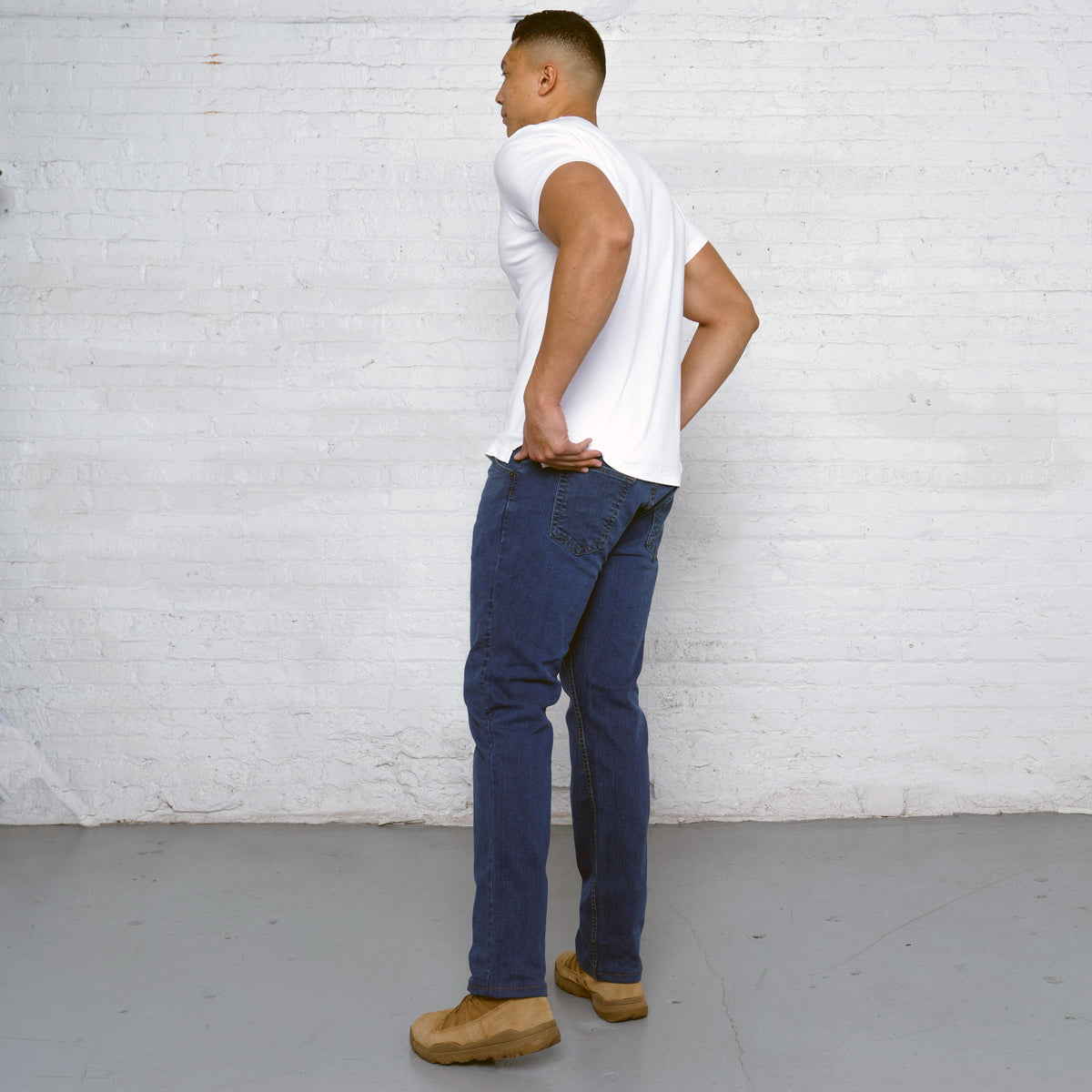 Detail of 10oz tri-blend stretch denim fabric and stitching on medium wash jeans