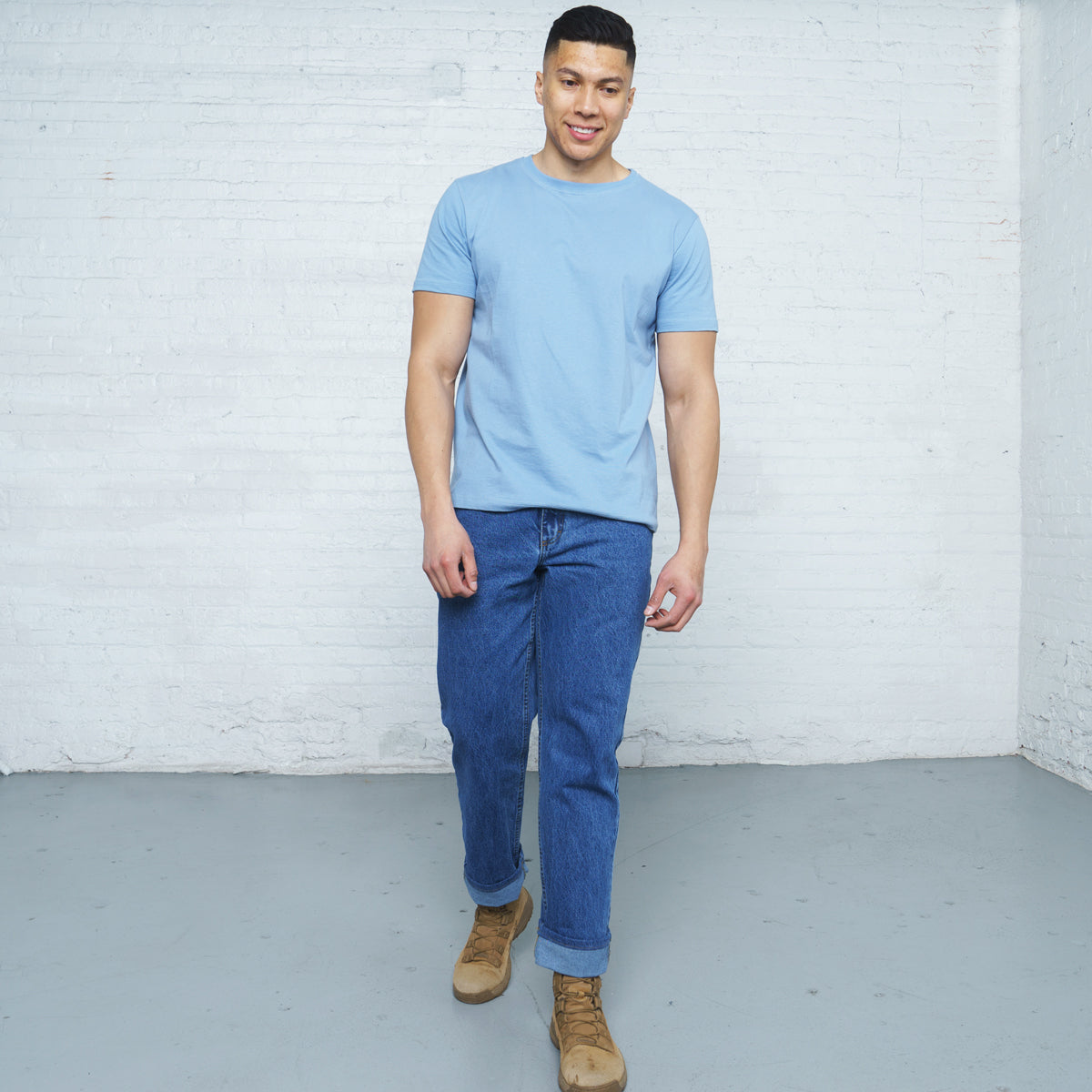 Back view of stone wash relaxed fit jeans showing rear pockets and Horween leather patch