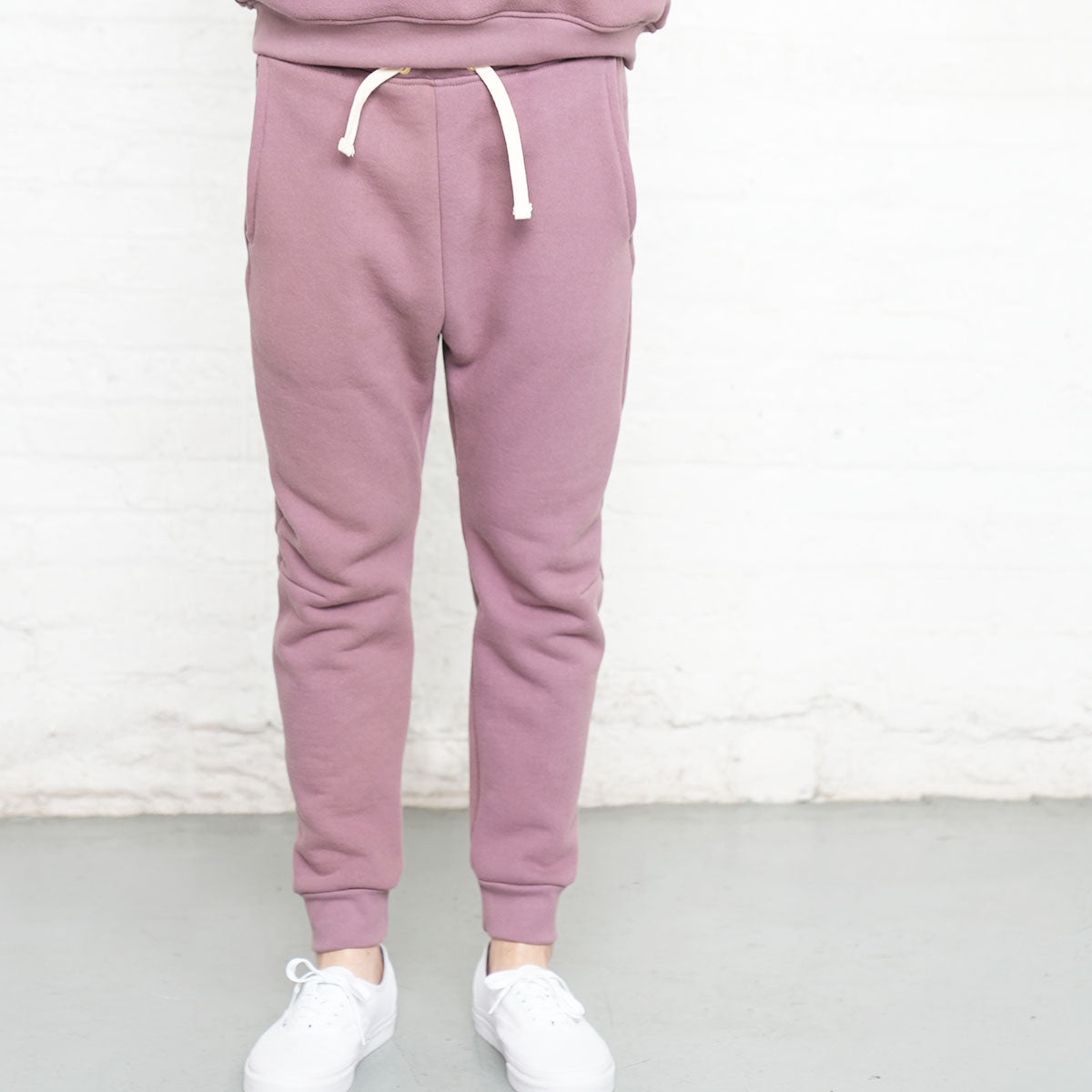 Detail of sweatpant waistband drawstring and cuffed ankle in rose taupe fleece.