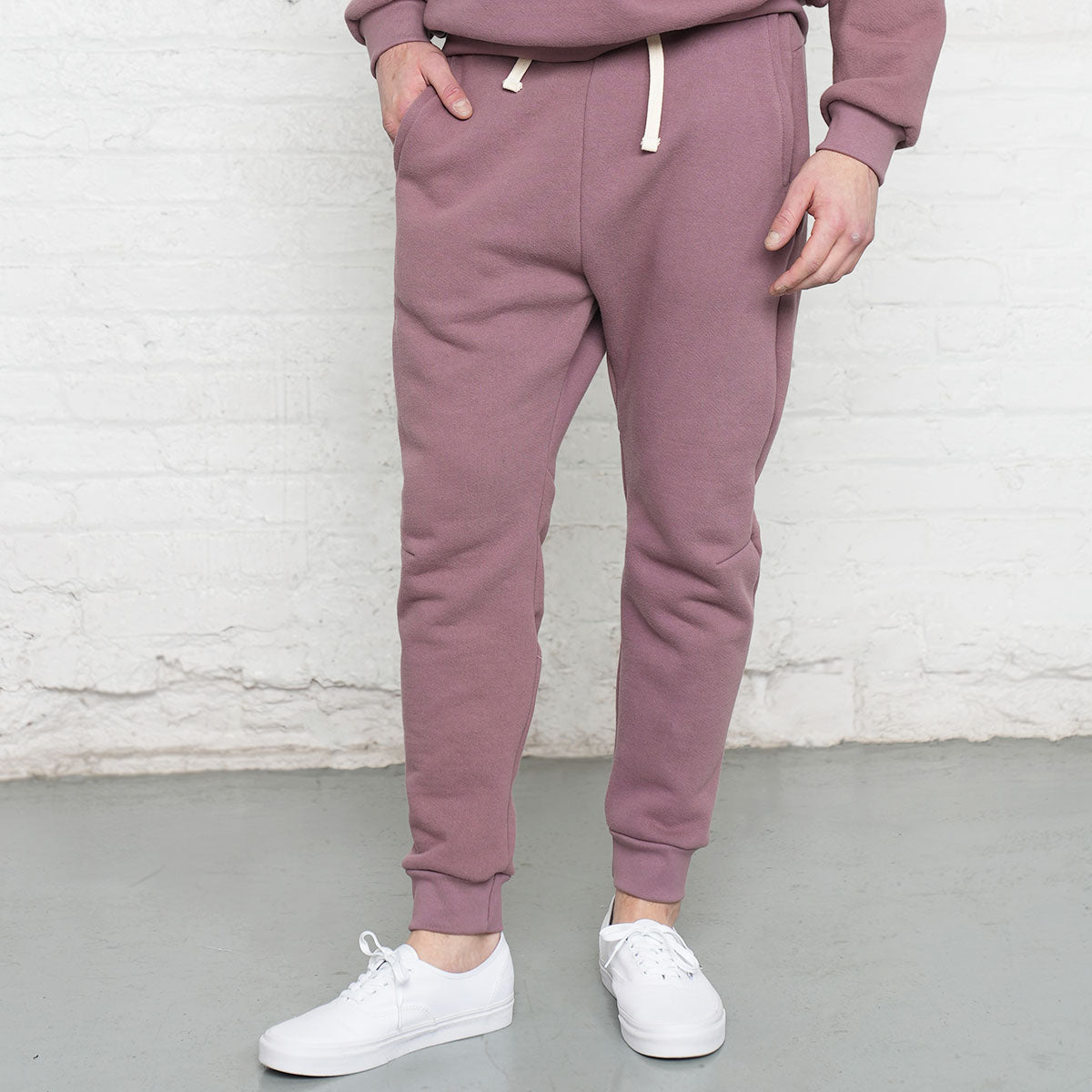 Rose taupe athletic fit sweatpants shown front view with elastic waistband and drawstring.