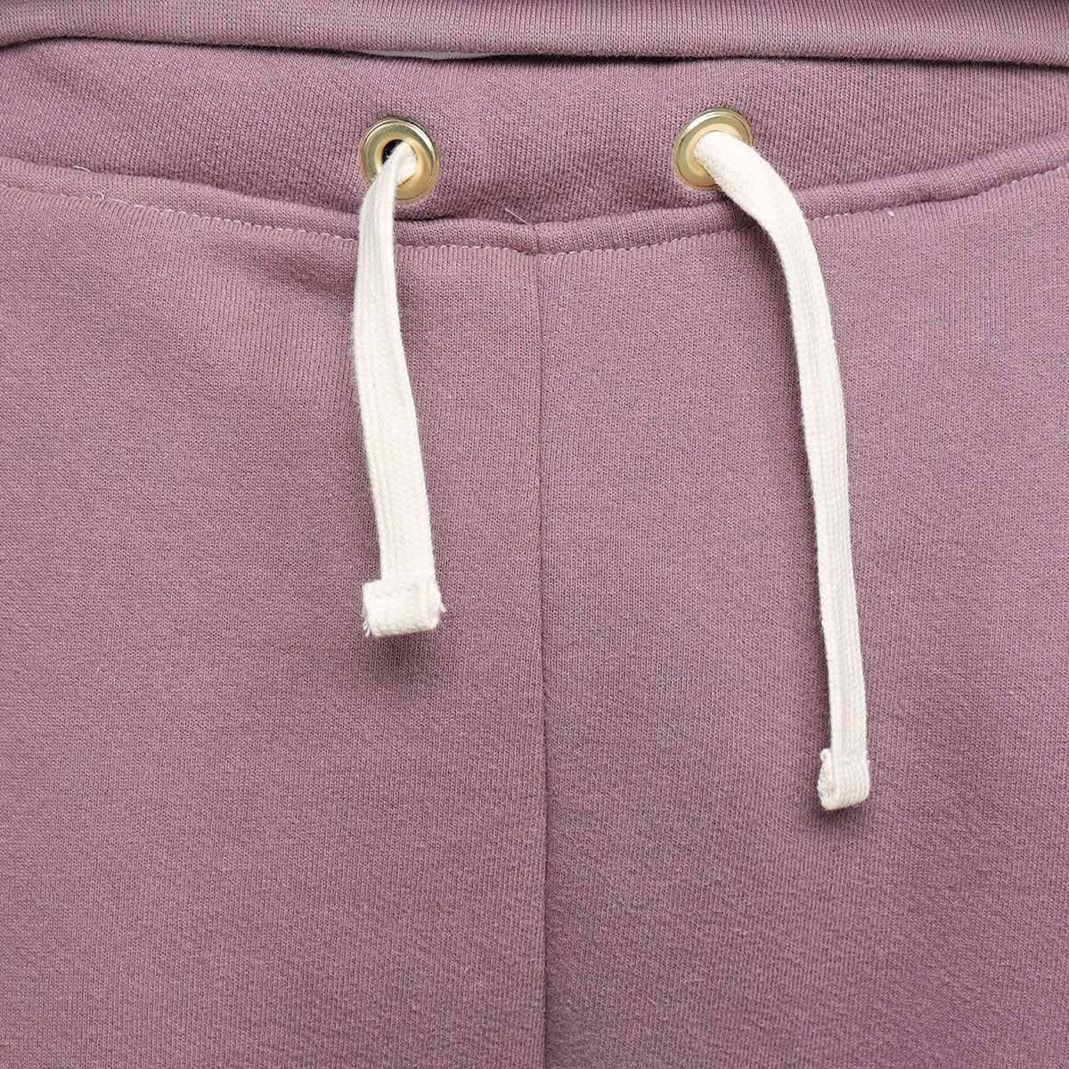 Close-up of 3 thread fleece fabric and stitching on rose taupe sweatpants.