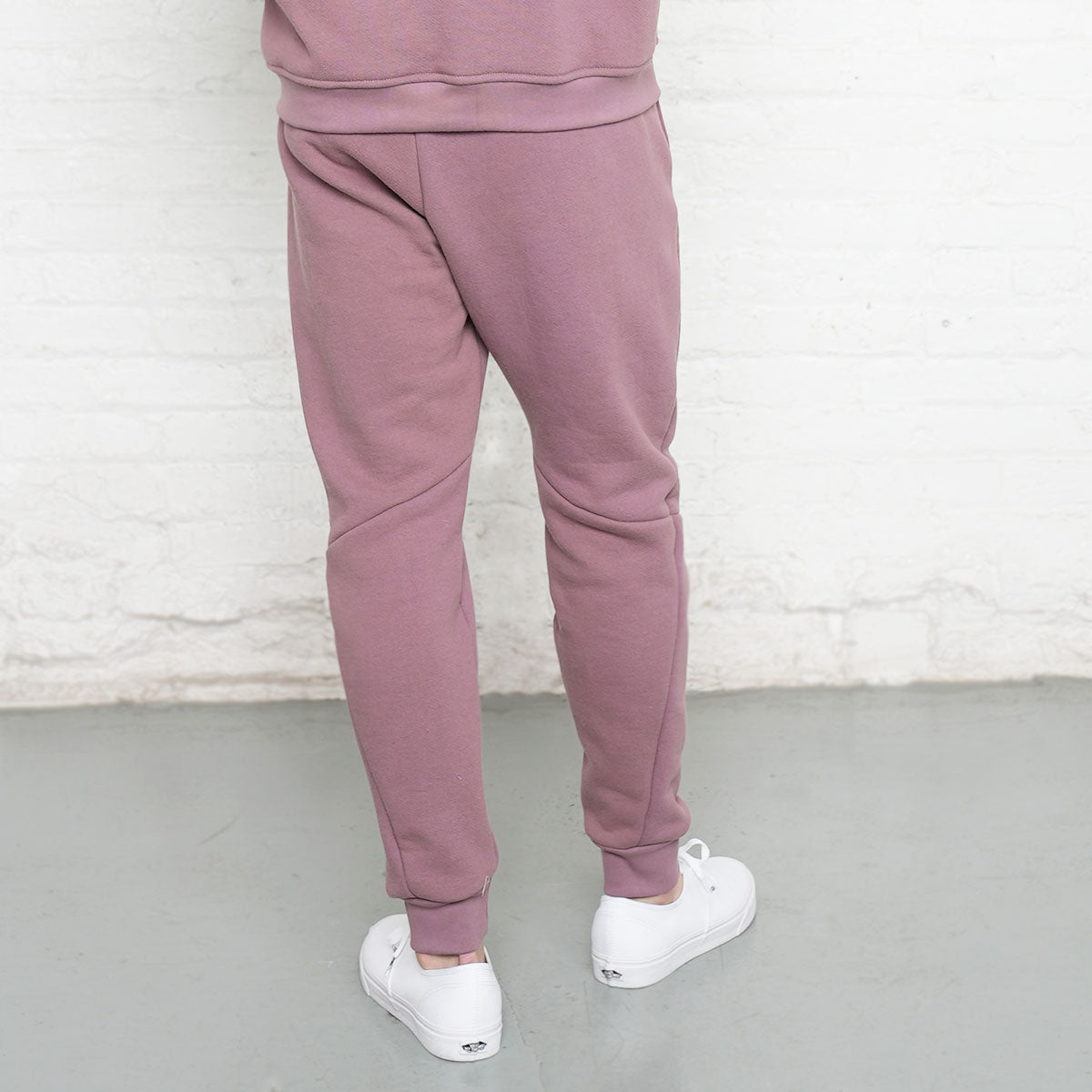 Side view of rose taupe sweatpants showing pocket opening and leg taper.