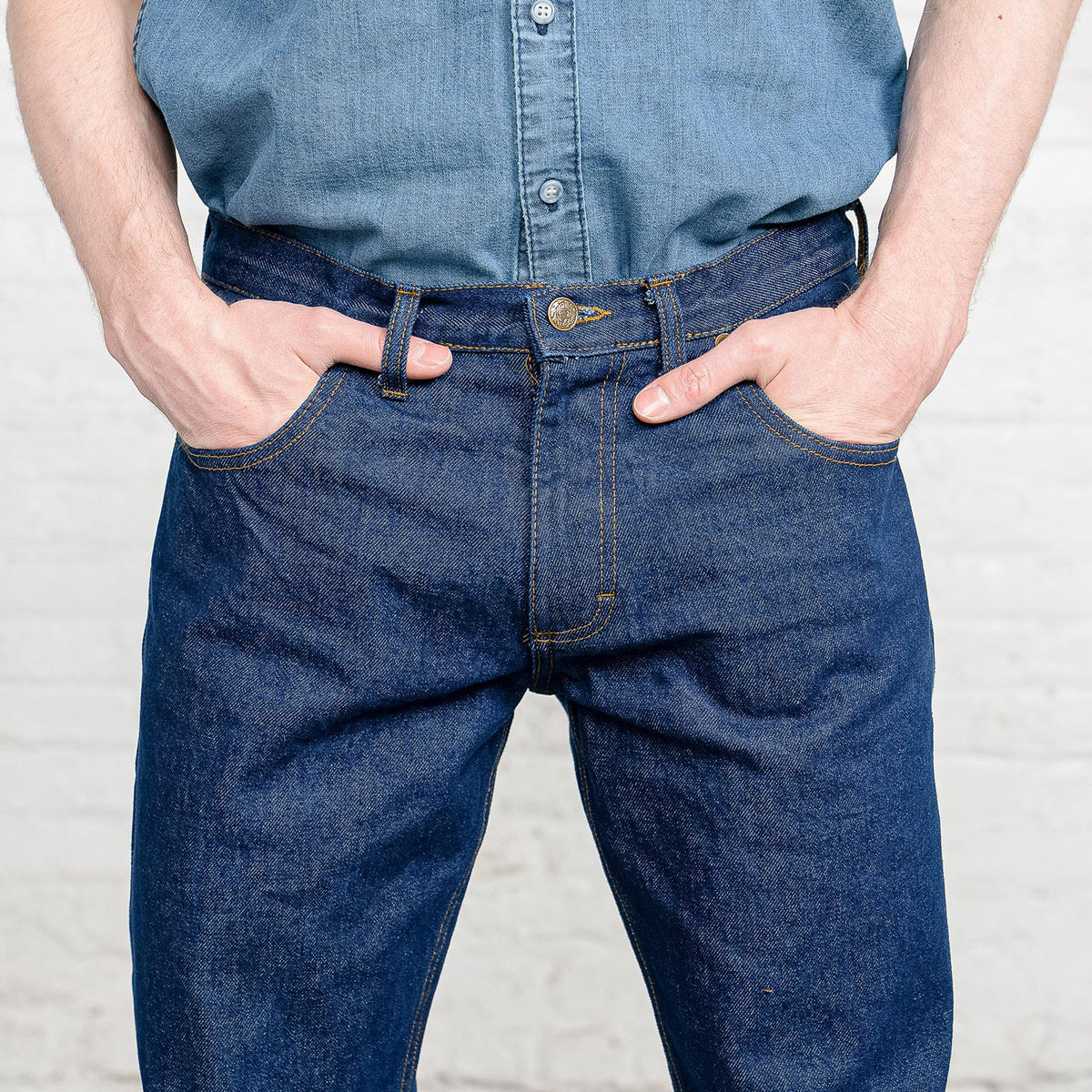 Man wearing dark wash Tailored Fit jeans with a t-shirt, side view